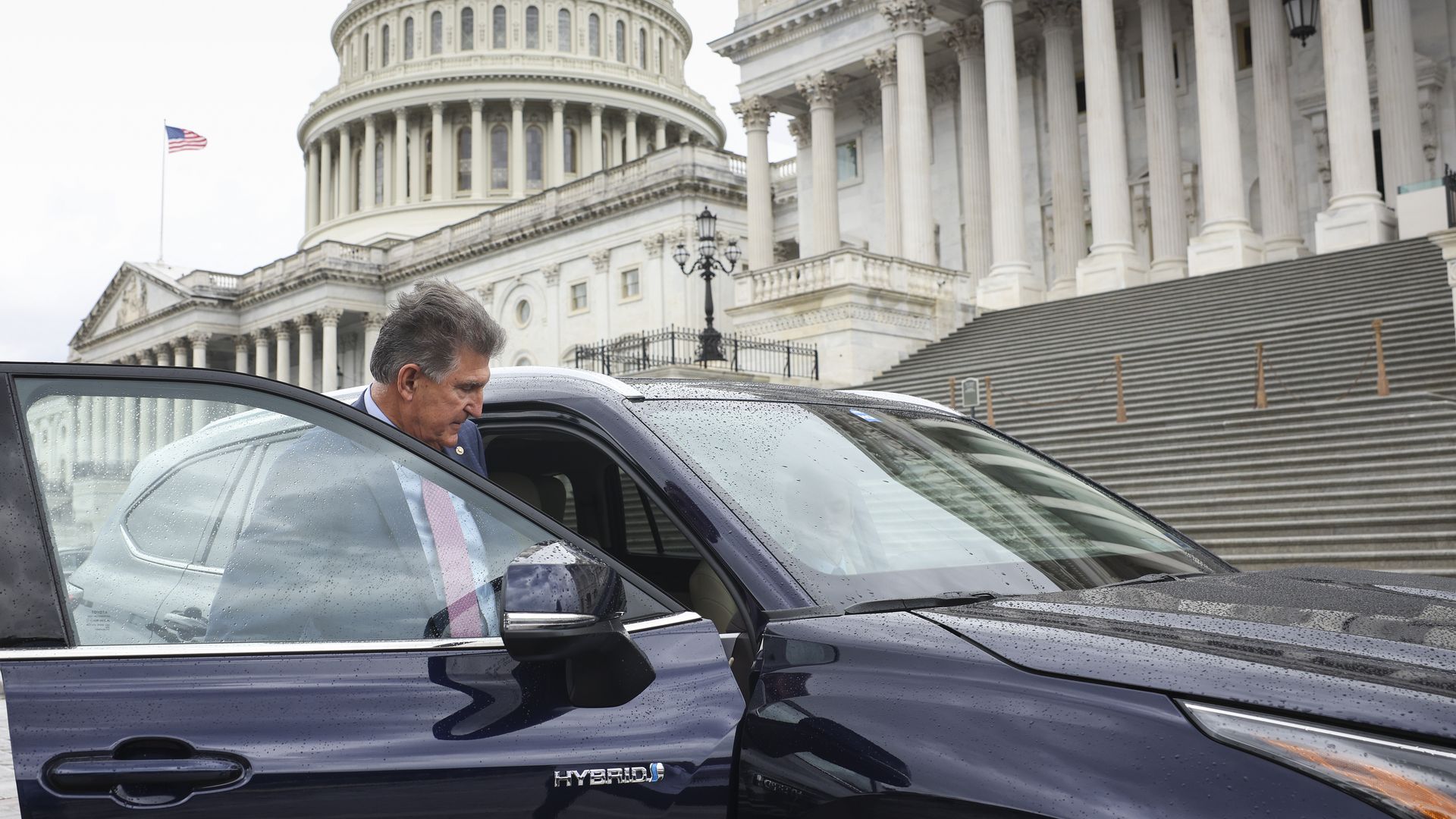 Sen. Joe Manchin is seen getting in his car for a drive to the White House on Wednesday.