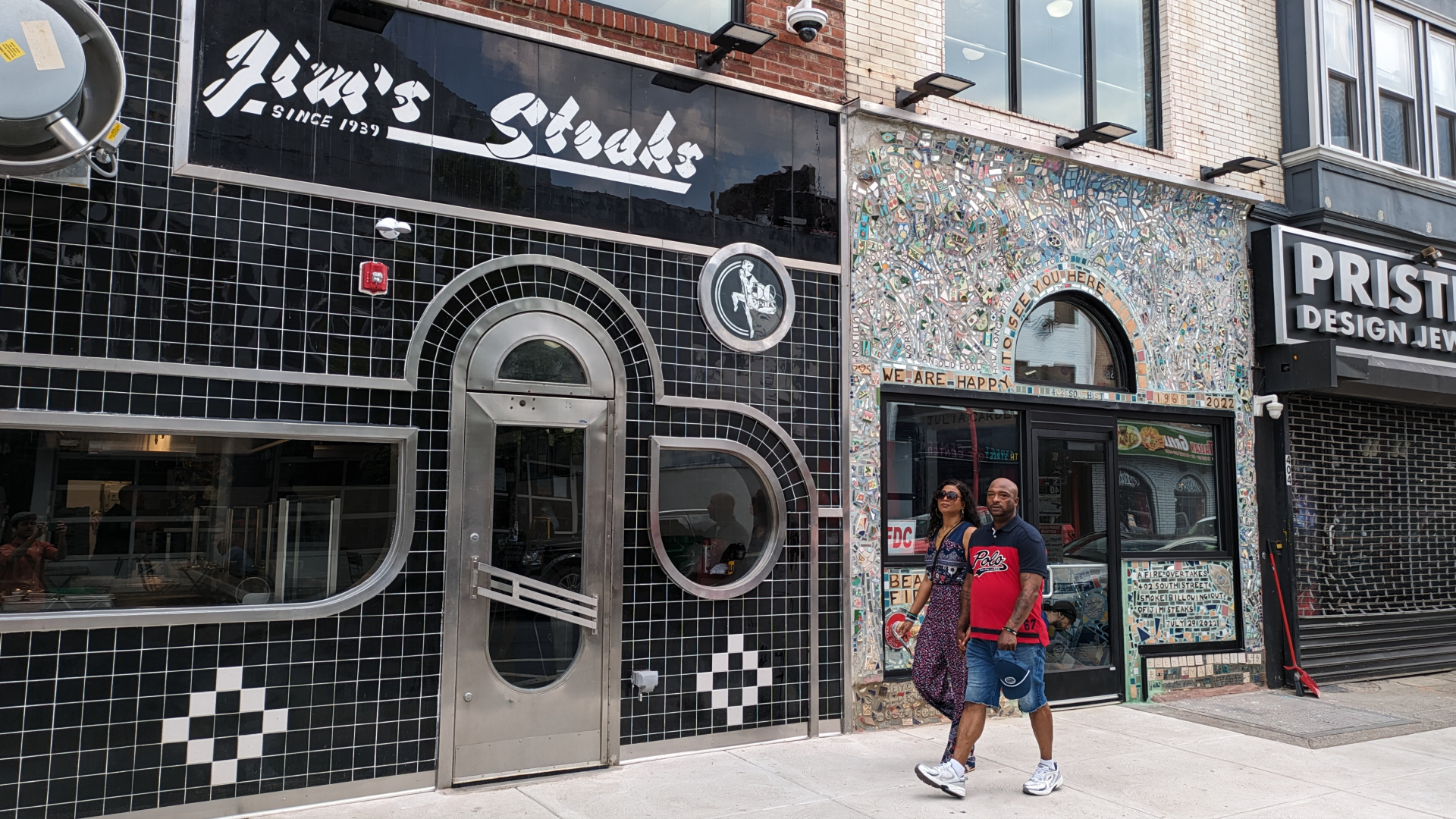 People walking outside Jim's Steaks on South Street in Philadelphia