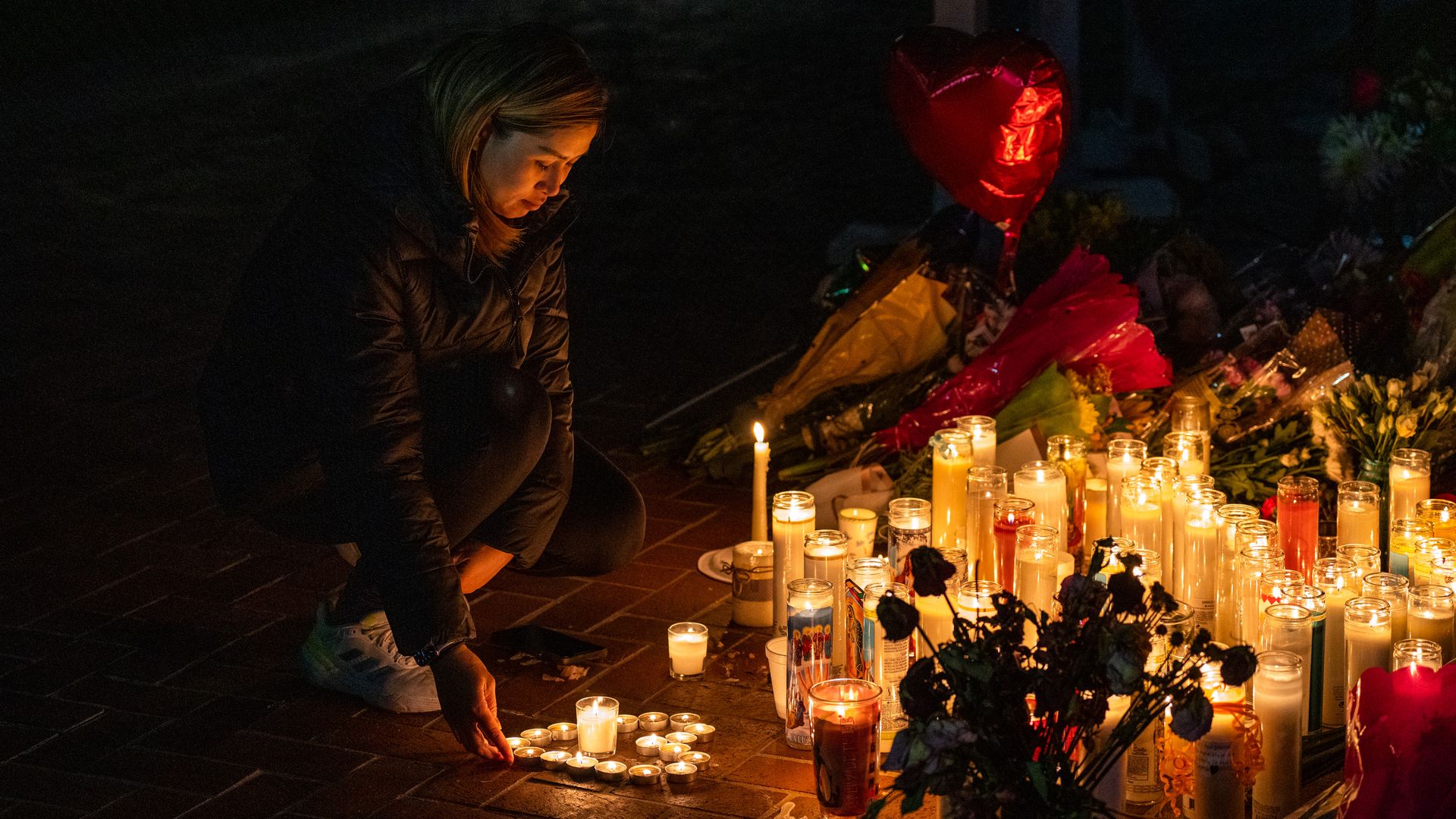  A mourner attends a candlelight vigil for victims of a mass shooting on January 23, 2023 in Monterey Park, California. 