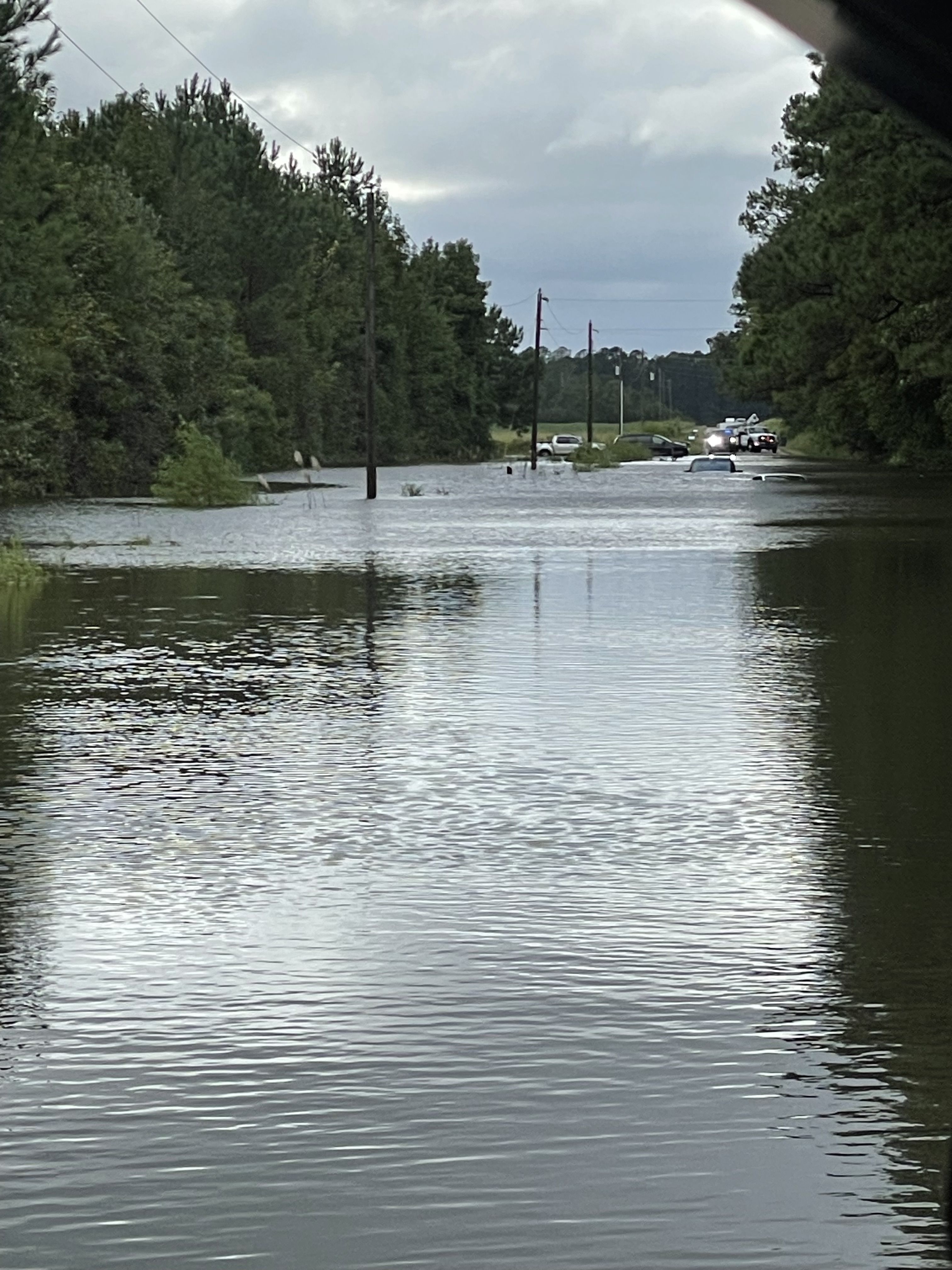 A road is submerged in water in Brunswick County, N.C.