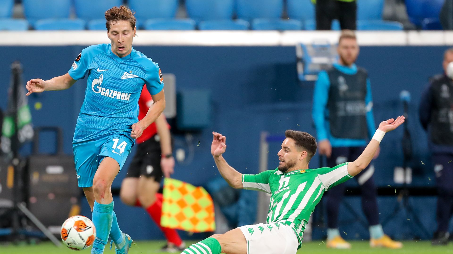 Soccer players reach for the ball