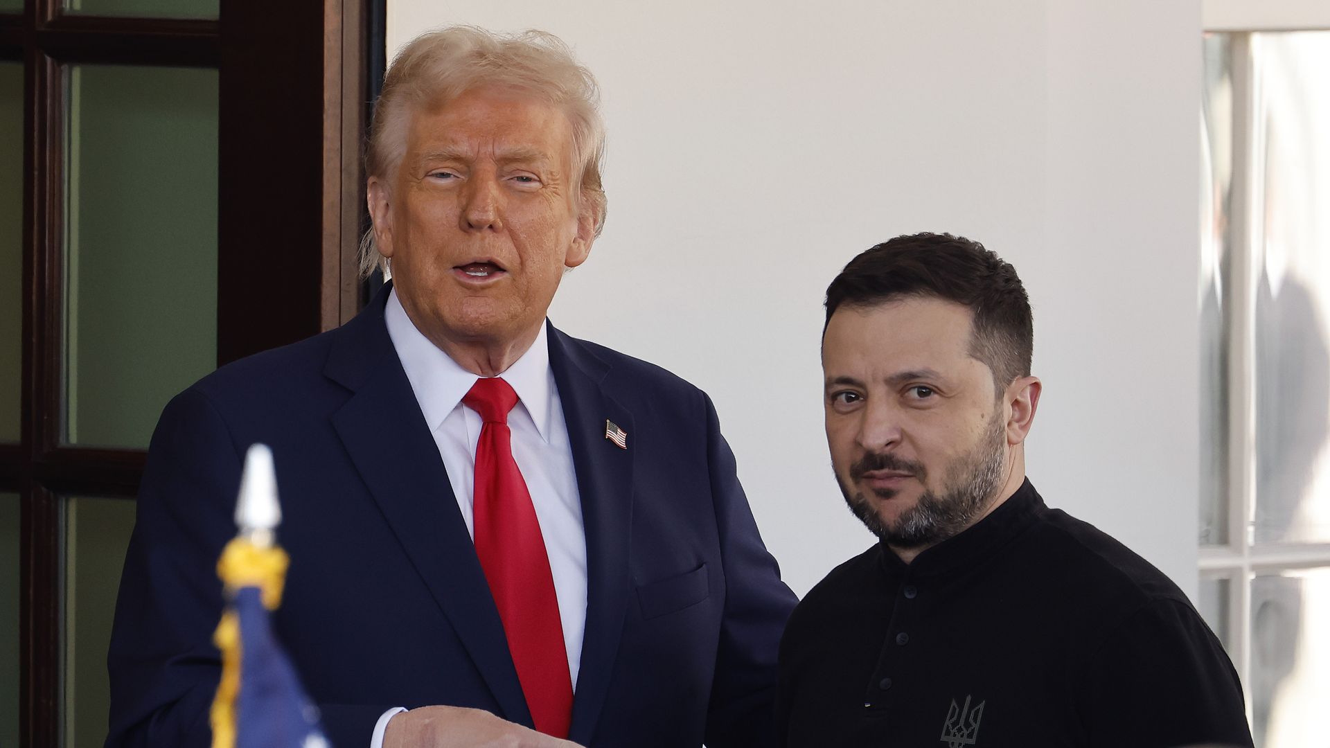 Trump points to Zelensky as he greets the Ukrainian president in front of the White House.