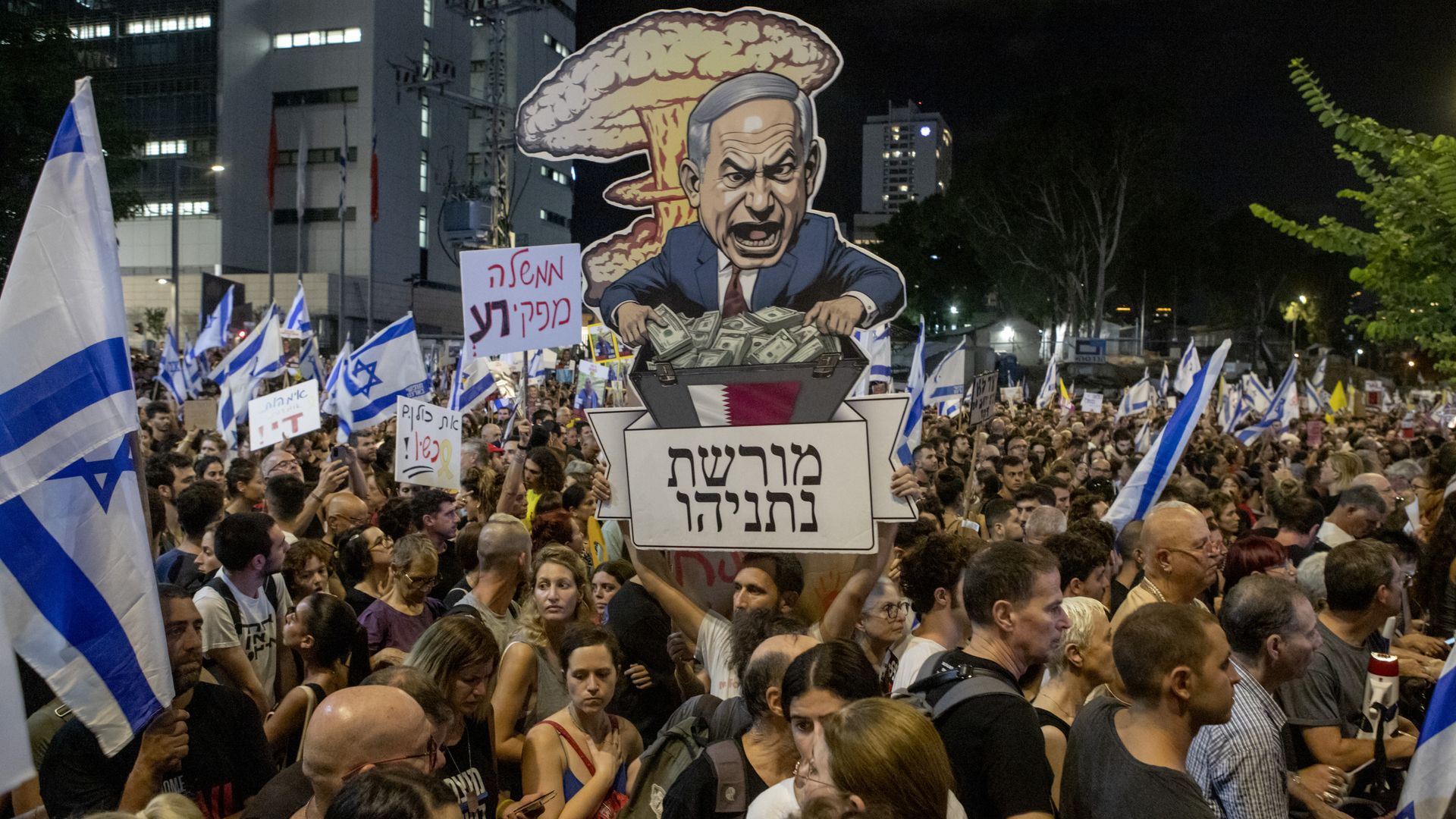 An Israel protester carries a poster reading in Hebrew "Netanyahu's Legacy" at a mass demonstration condemning Prime Minister Benjamin Netanyahu and his handling of the hostages being held by Hamas in Gaza on September 1, 2024 in Tel Aviv, Israel. 