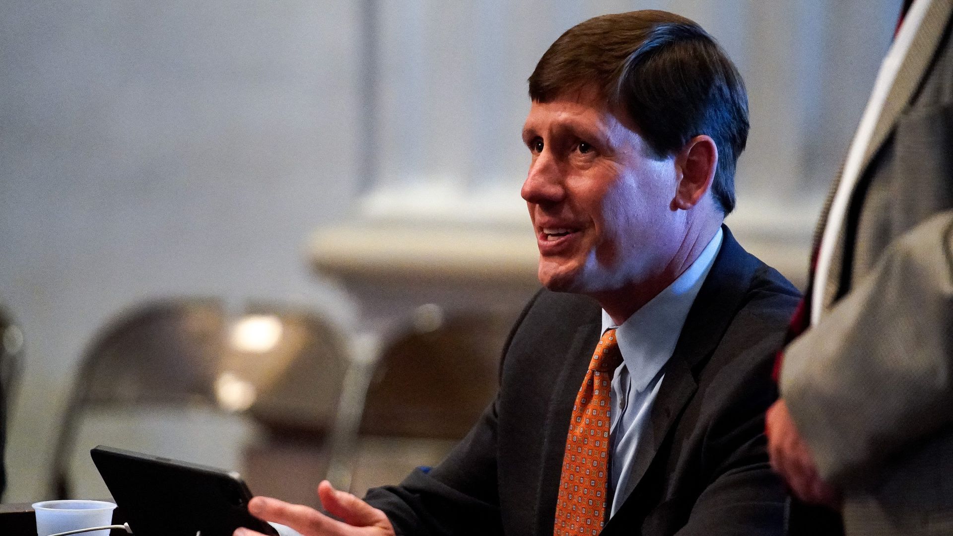 Embattled state Sen. Brian Kelsey sitting down in front of a tablet