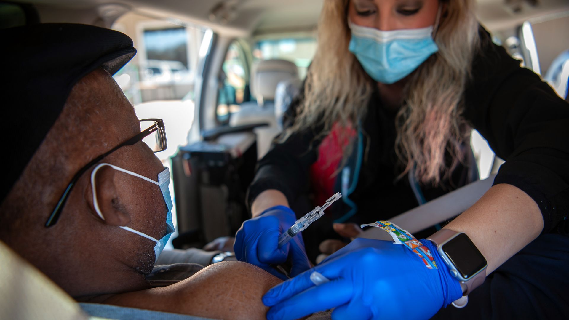 A health care worker administers a dose of the Moderna vaccine in Ruleville, Mississippi.