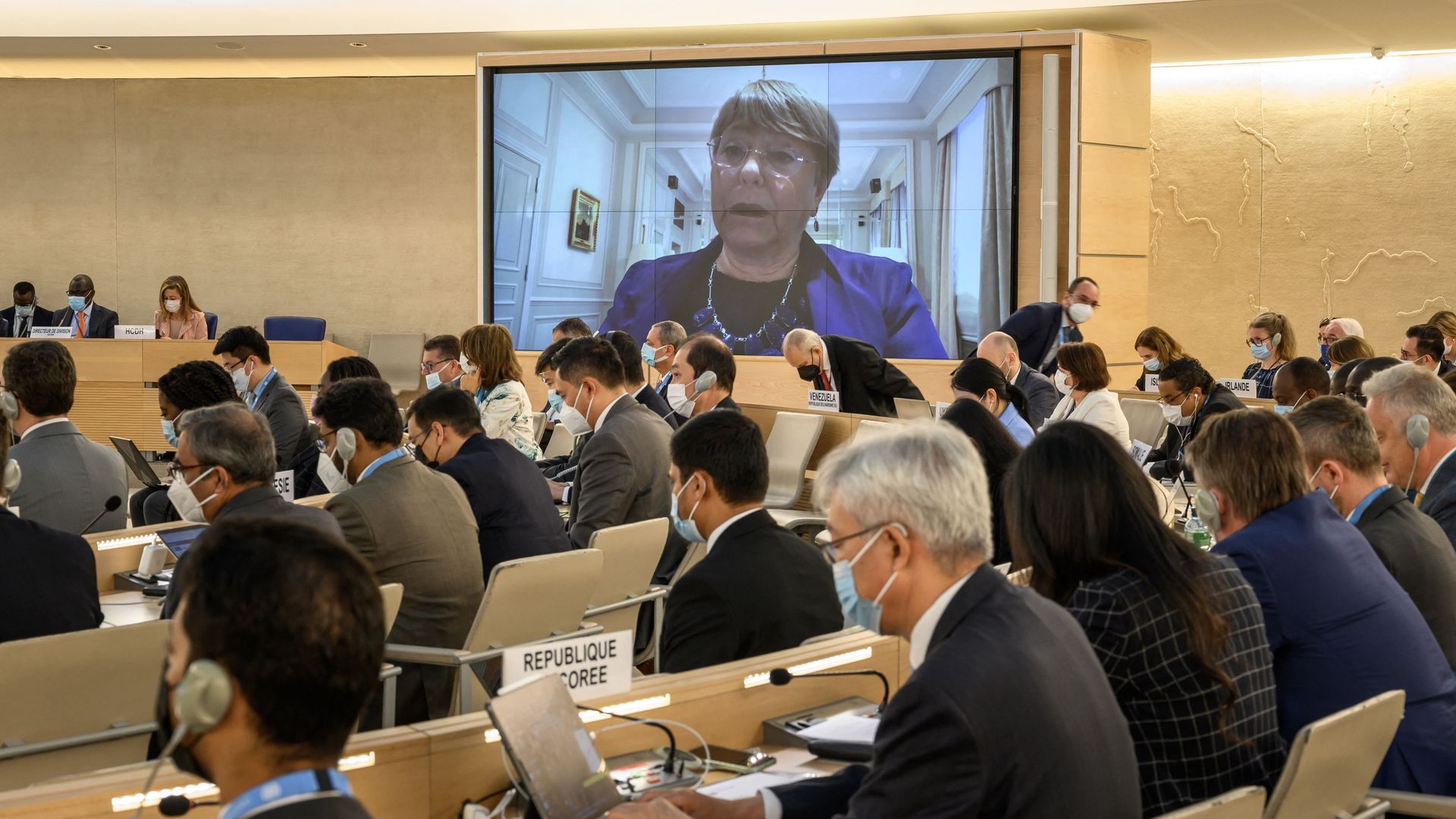 United Nations High Commissioner for Human Rights Michelle Bachelet is seen on a giant screen delivering a remote speech 