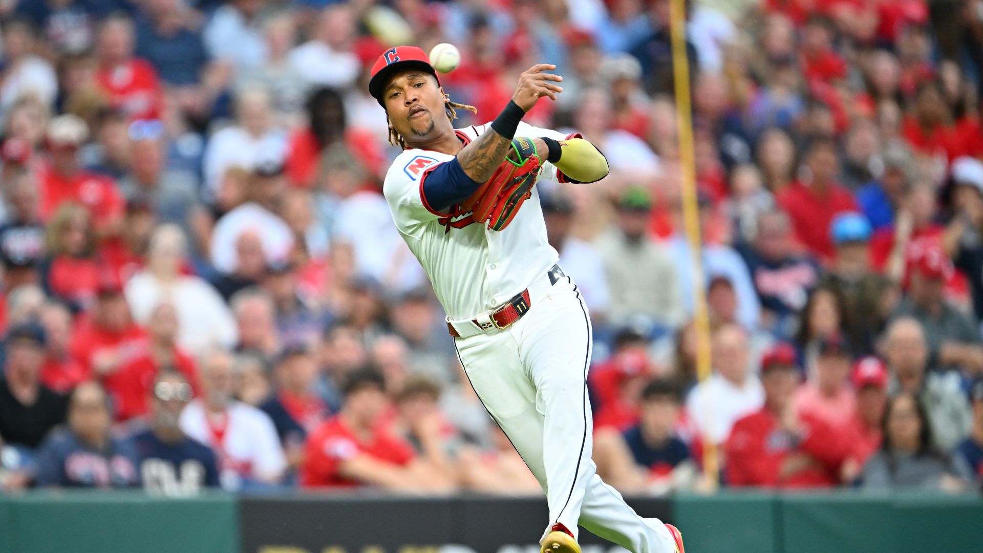 Cleveland Guardians third baseman José Ramírez throws out a player during a baseball game.
