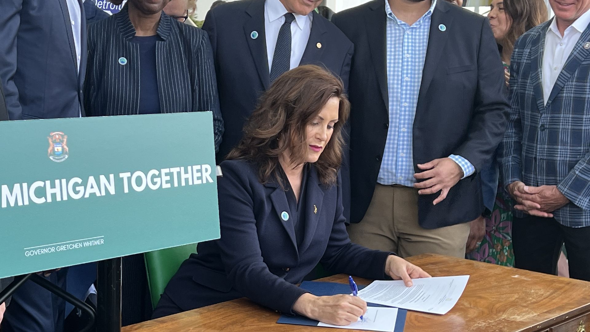 Whitmer signing an executive order to create the Grow Michigan Together Council to address the state's stagnant population growth.