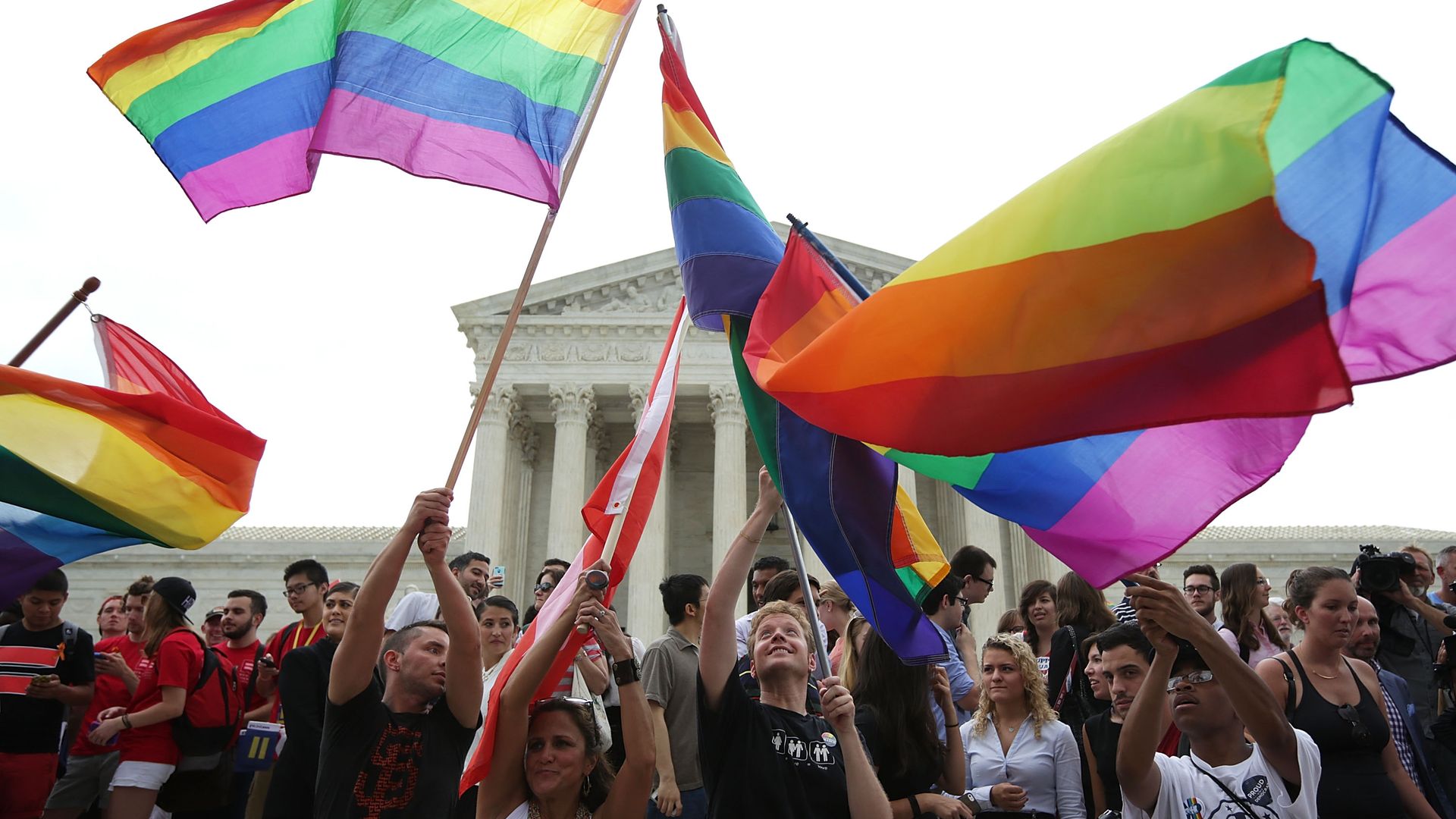 People waving the gay pride flag.