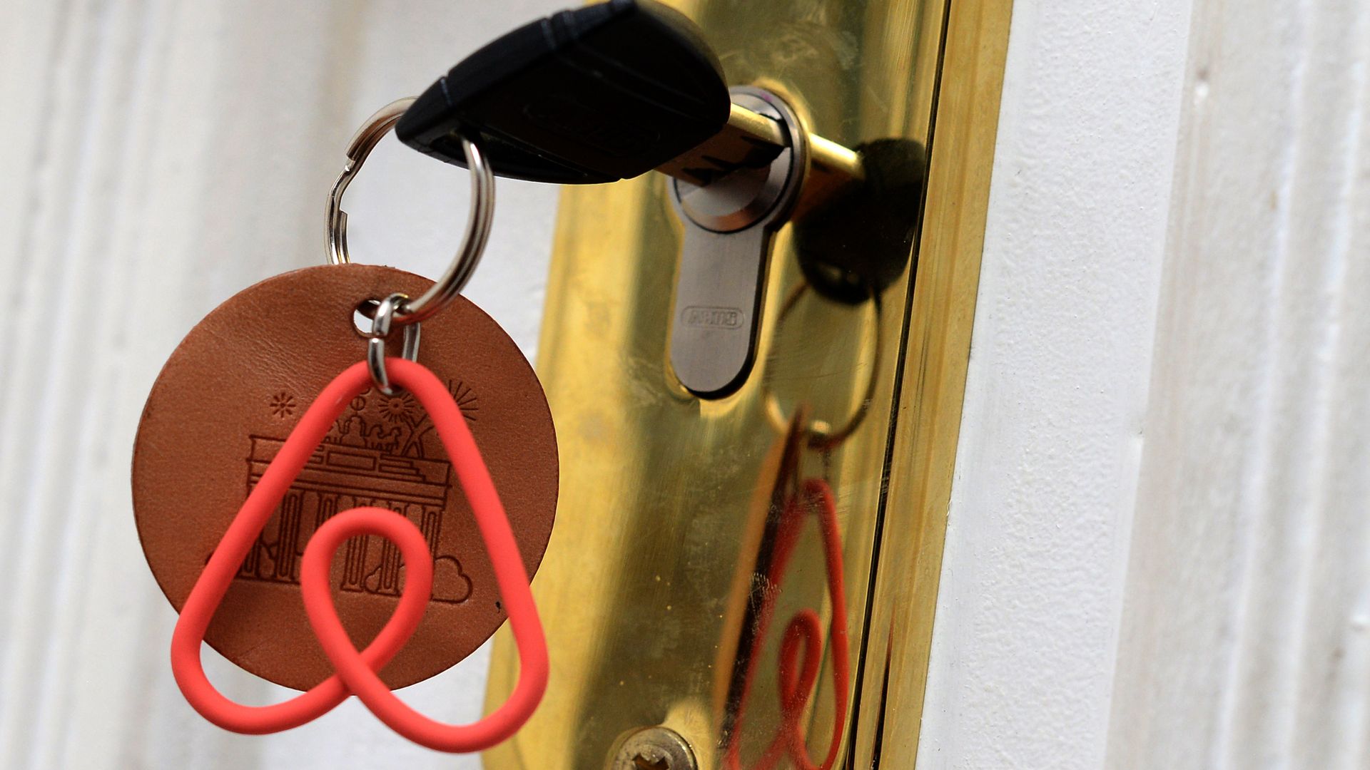 Photo of key ring with Airbnb logo in a door lock