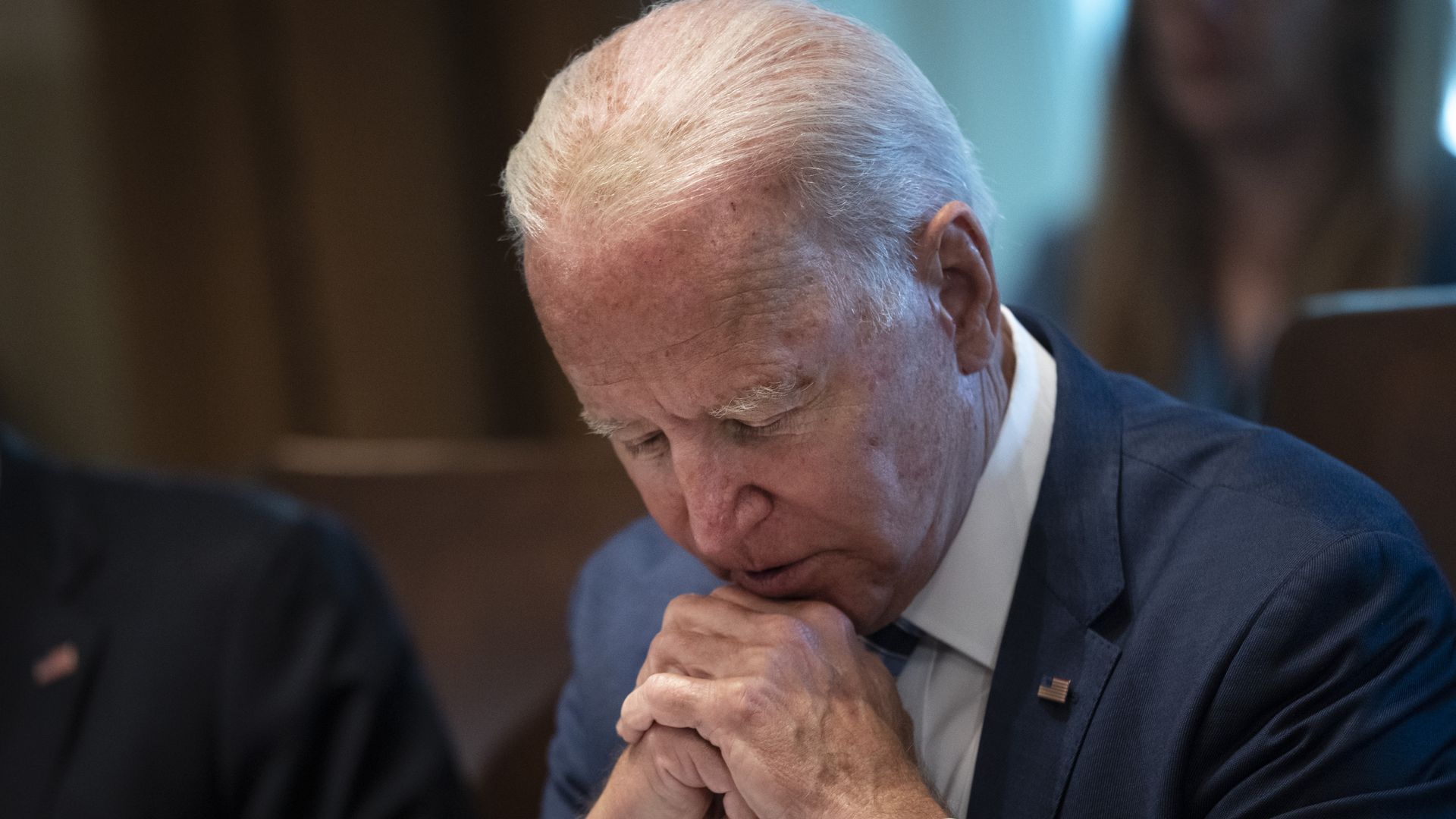 Joe Biden, bowing his head