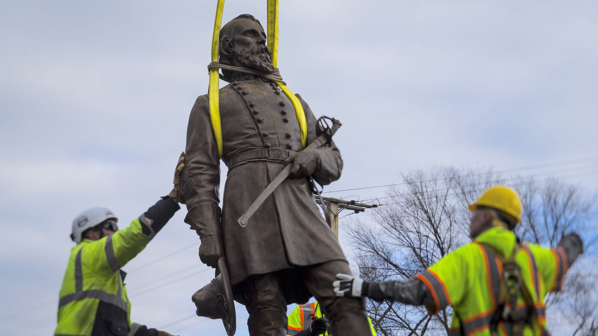 A crane lifts a statue of Confederate Gen. A.P. Hill.