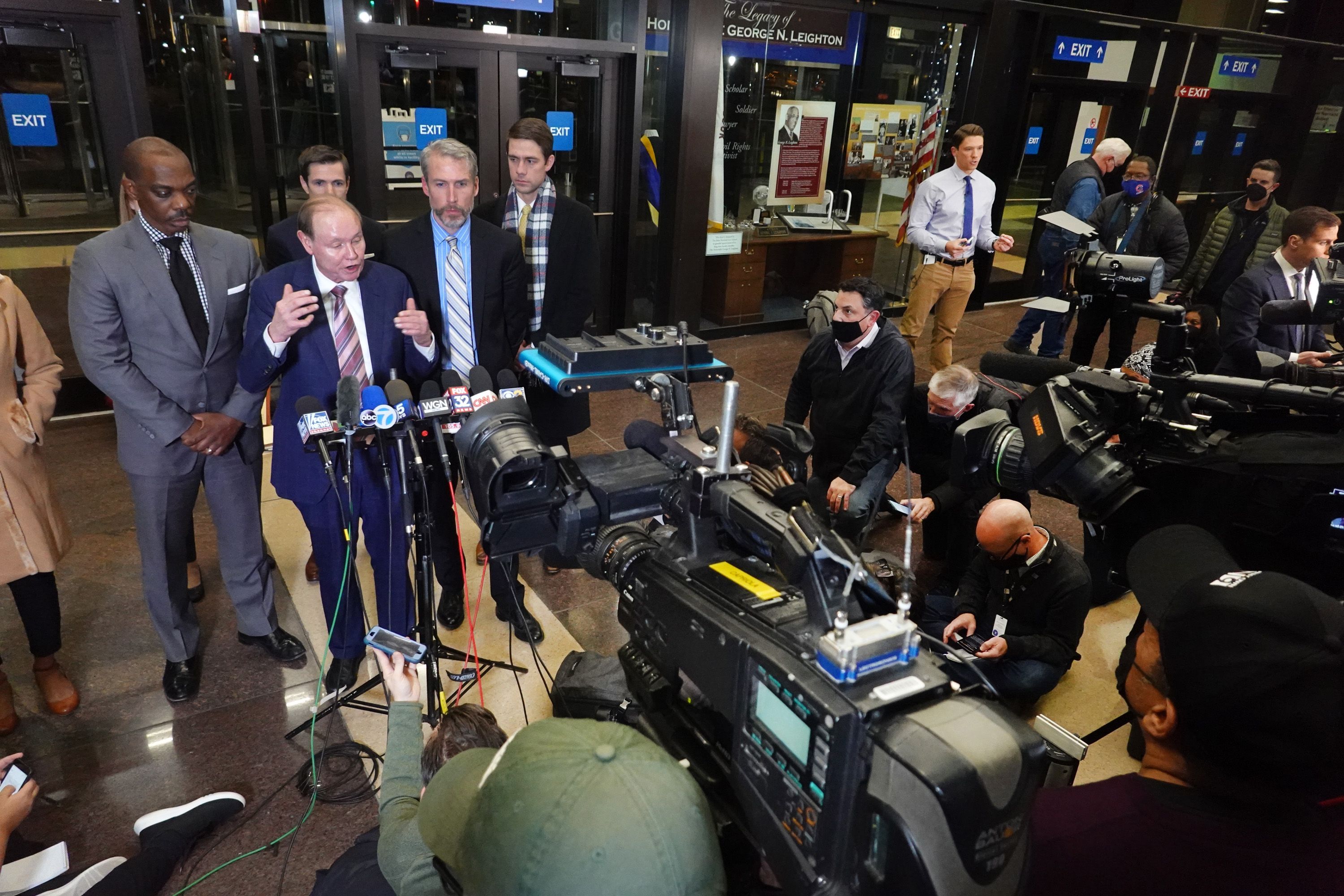 Lawyer at microphone at press conference.