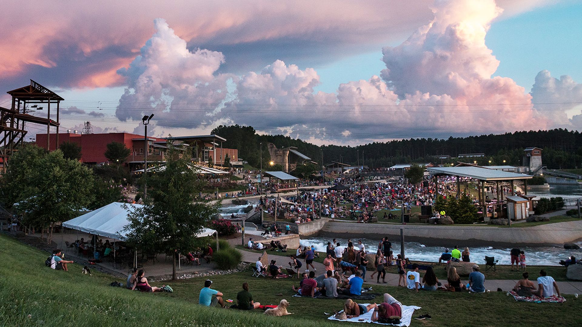 sunset at the US National Whitewater Center with a crowd of people watching music
