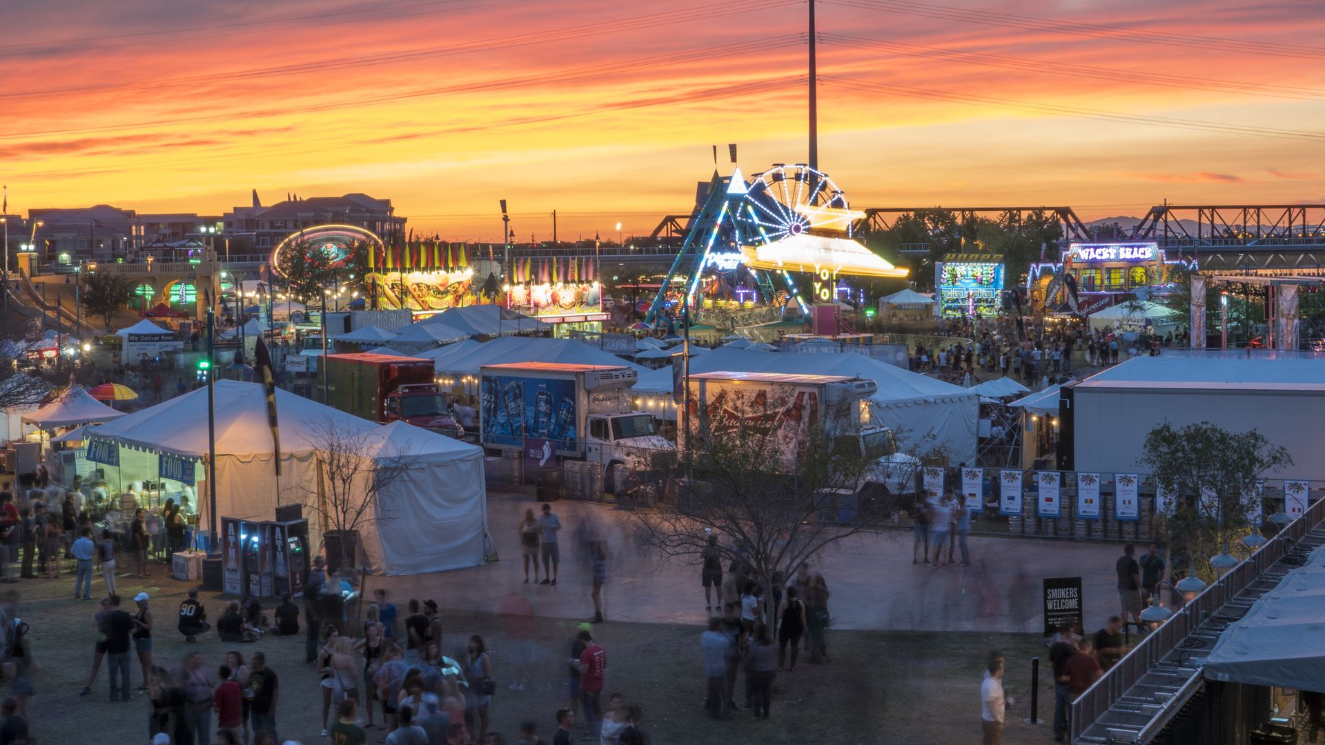 A fair with the sunset in the background. 