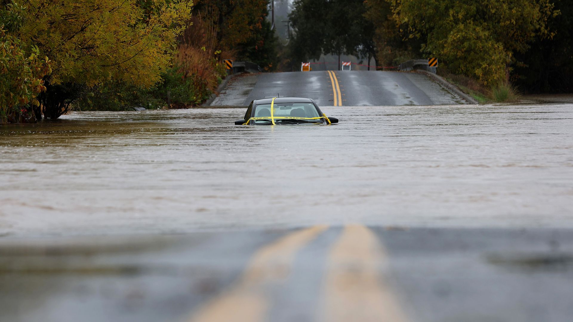 A car sits submerged in floodwater on November 21, 2024, in Windsor, California. An atmospheric river is bringing heavy rains and wind to the San Francisco Bay Area for a second day and is expected to rain through the weekend. 