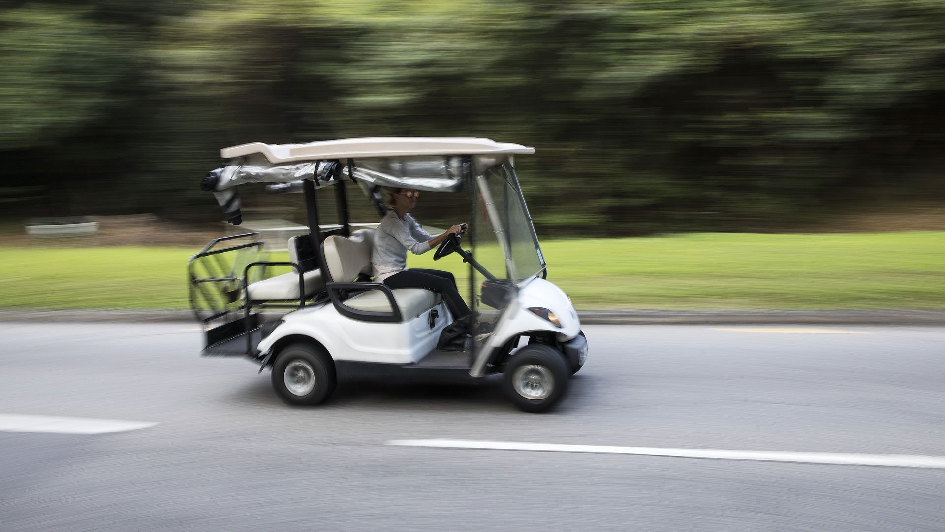 A golf cart travels along a road in Discovery Bay, a residential project developed by Hong Kong Resort Co., on Lantau Island in Hong Kong, China, on Tuesday, March 27, 2018
