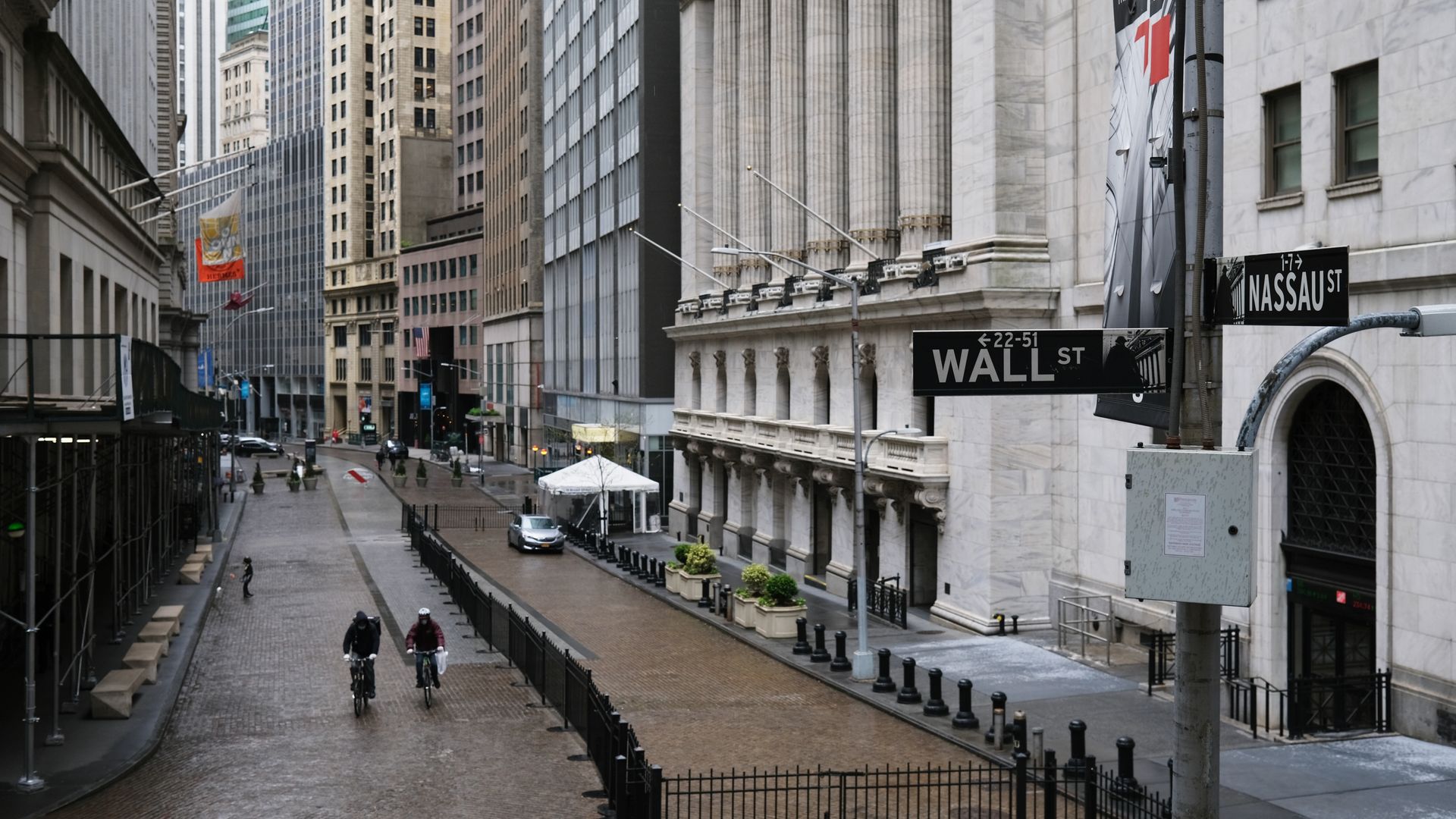 People walk across from the Stock Exchange