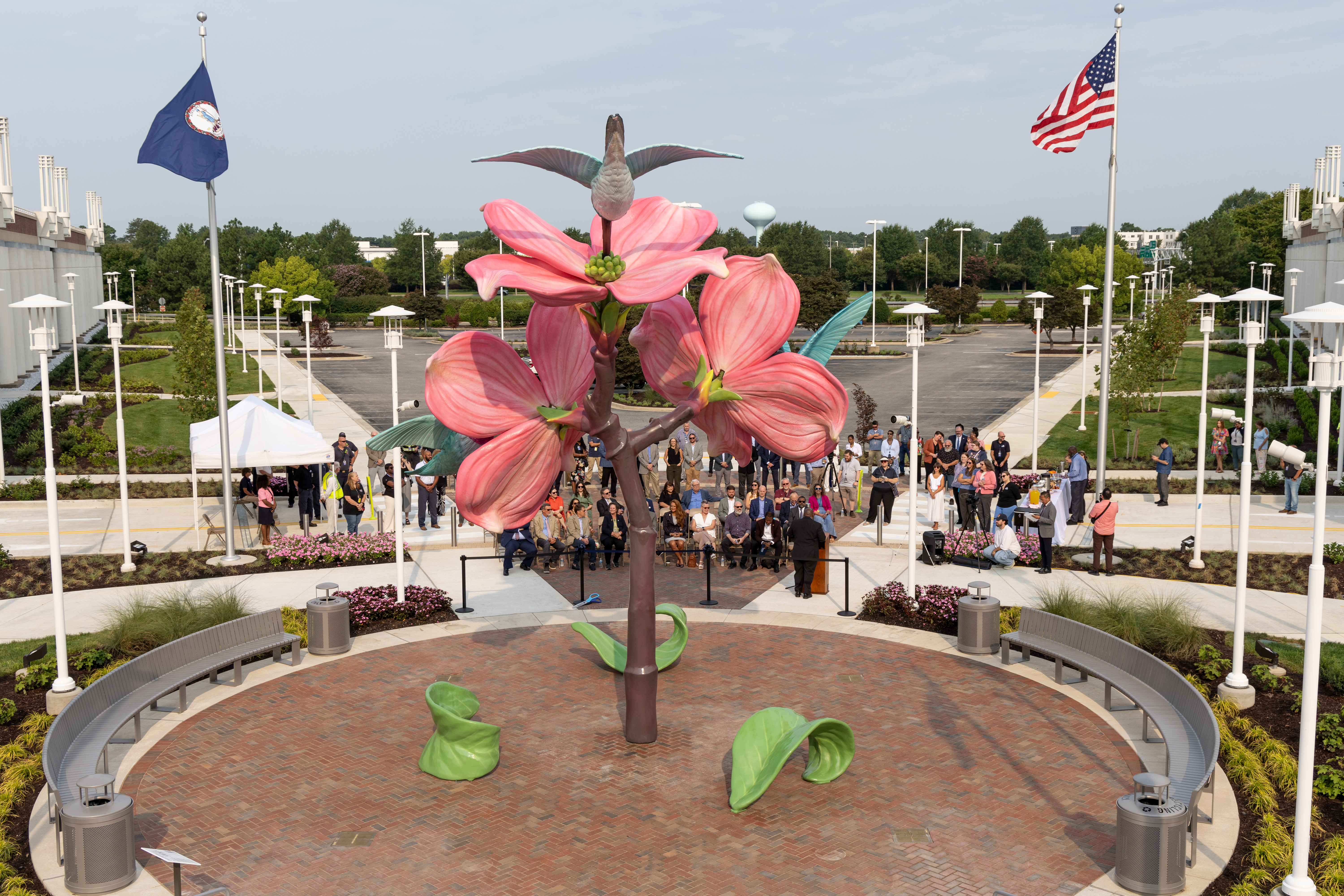An aerial view of the pink and brown sculpture with hummingbirds and a brick courtyard