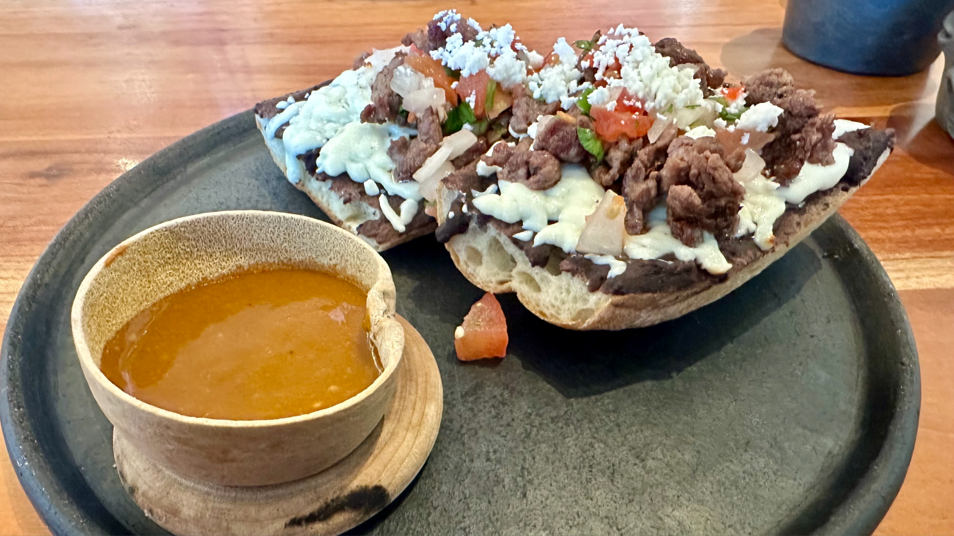 A photo of a baguette, steak and salsa breakfast