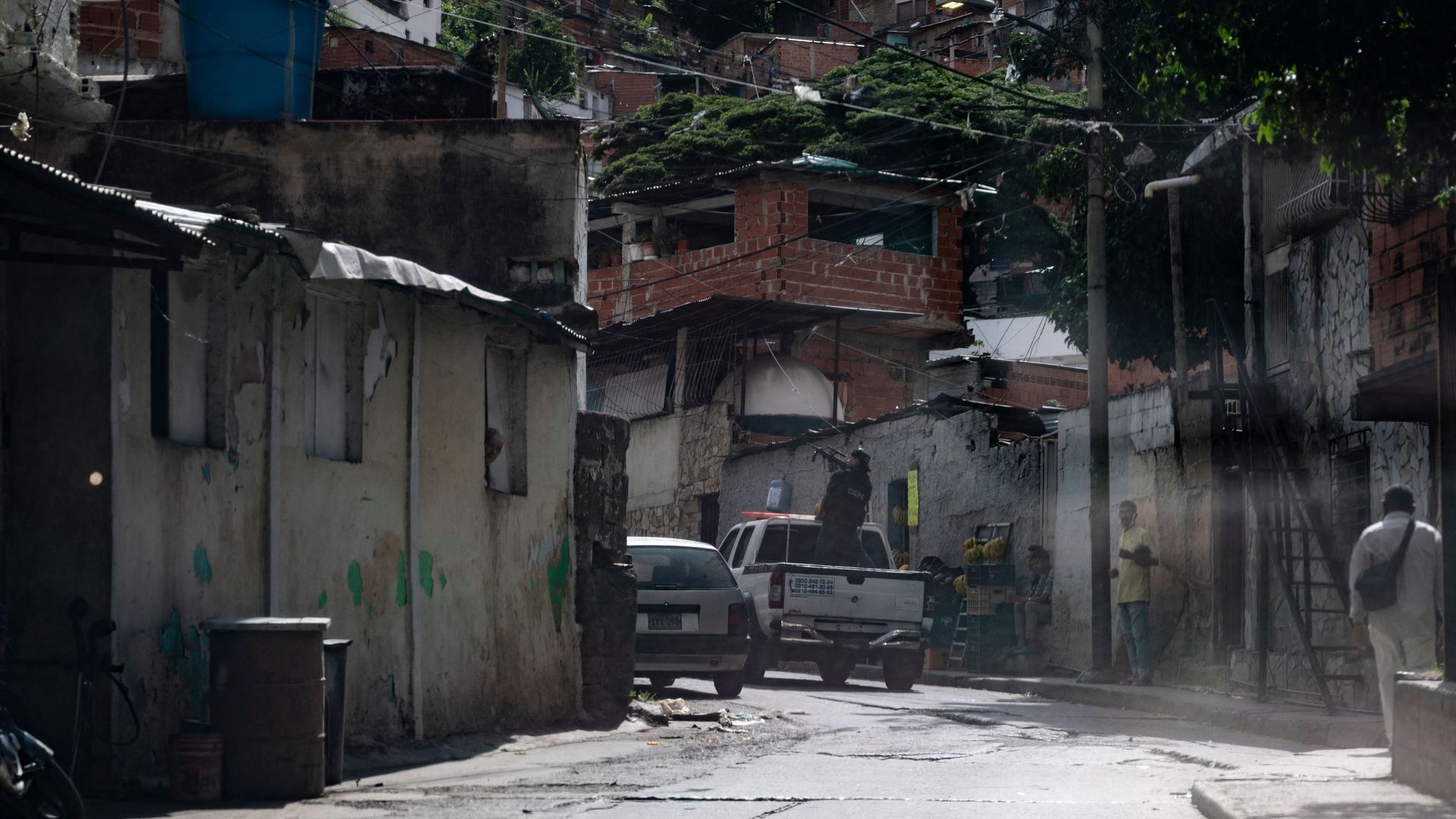 Security forces aim their guns while patrolling the Cota 905 and El Valle neighborhoods of Caracas during clashes with gangs, July 8.