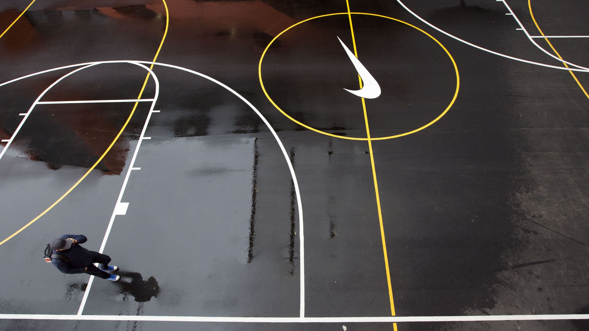 A man walks on a basketball court at Nike headquarters.