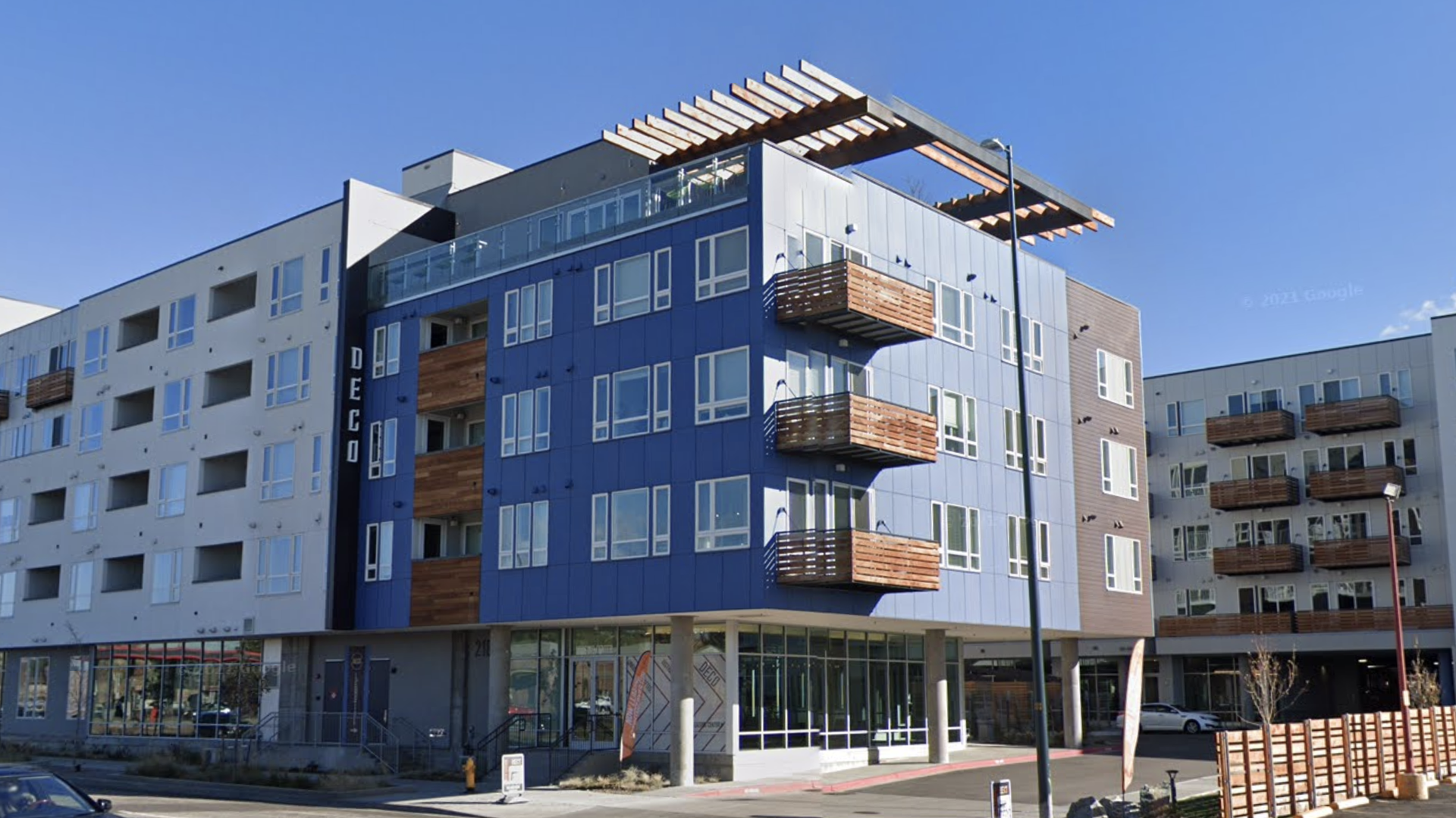 A picture of a five-story apartment building in Denver with balconies.