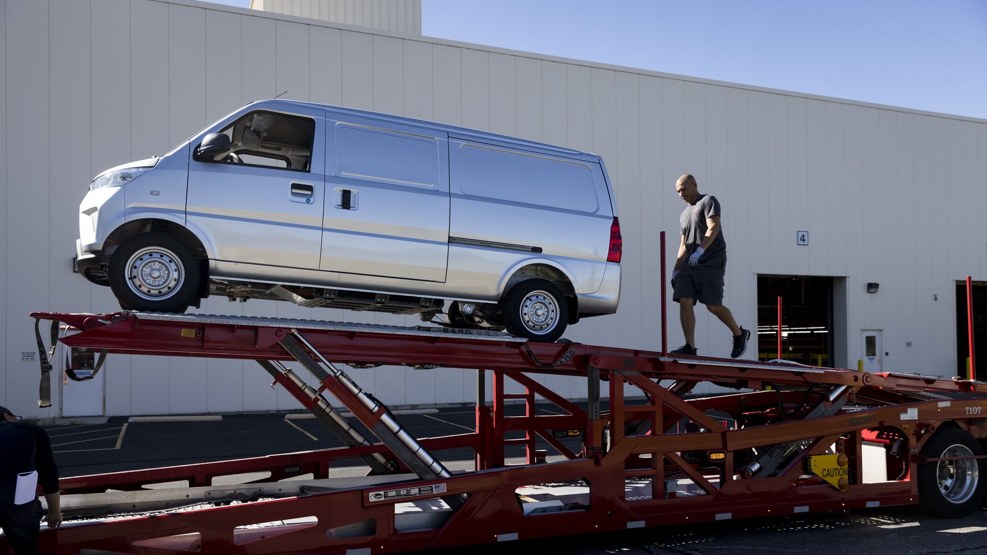 A gray van on top of a vehicle-hauler