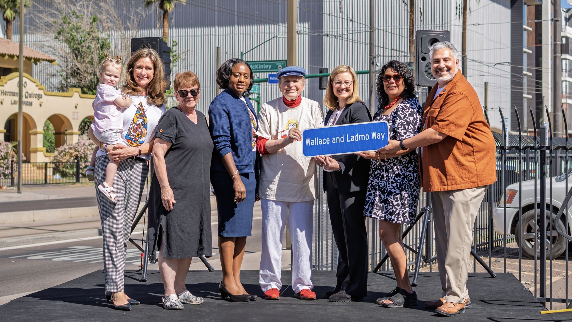 Pat McMahon and six members of the Phoenix City Council pose with a sign that reads "Wallace and Ladmo Way".