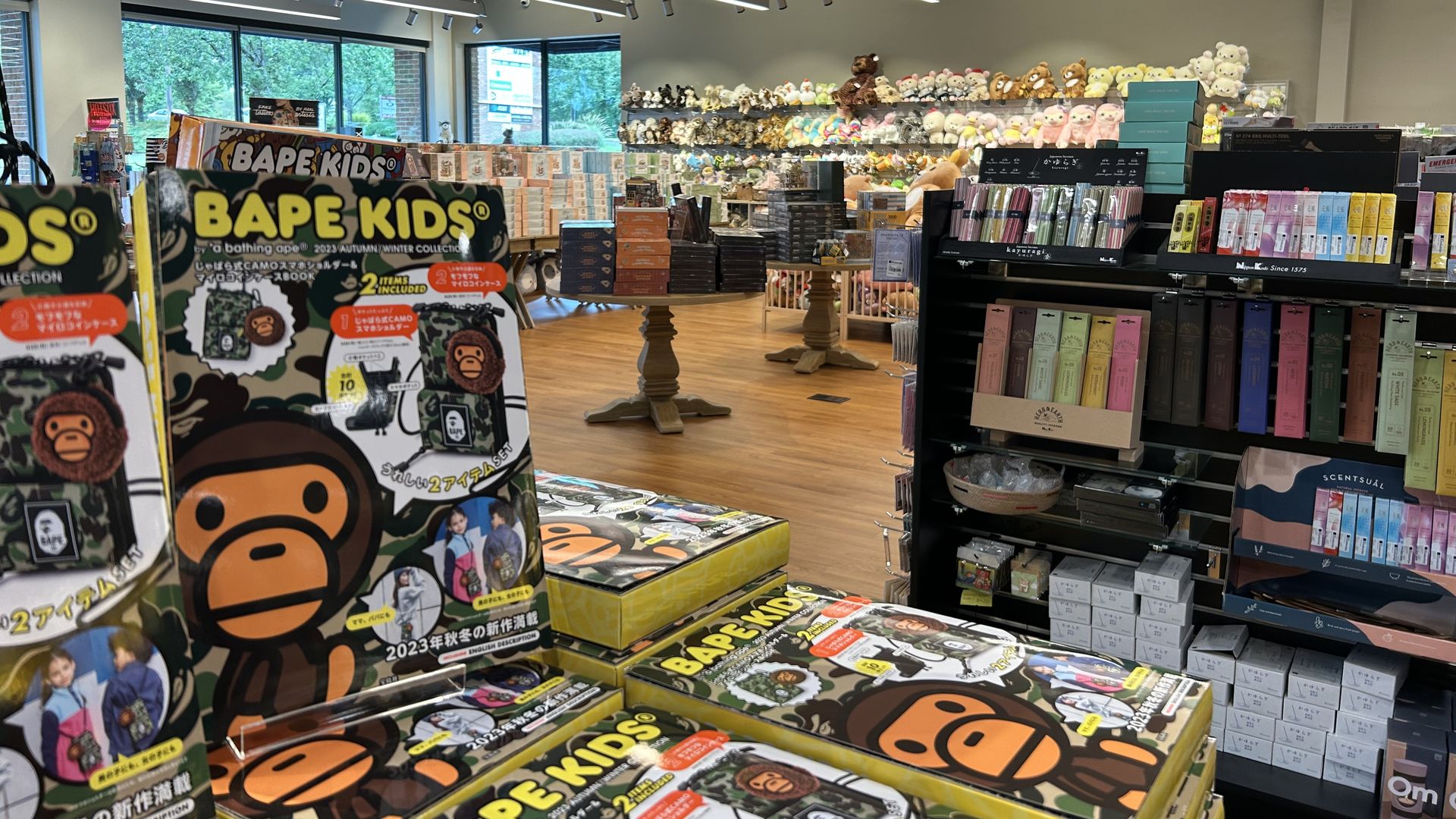 A stack of books on a table reading "Bape Kids" in a store filled with Japanese-designed or -made products