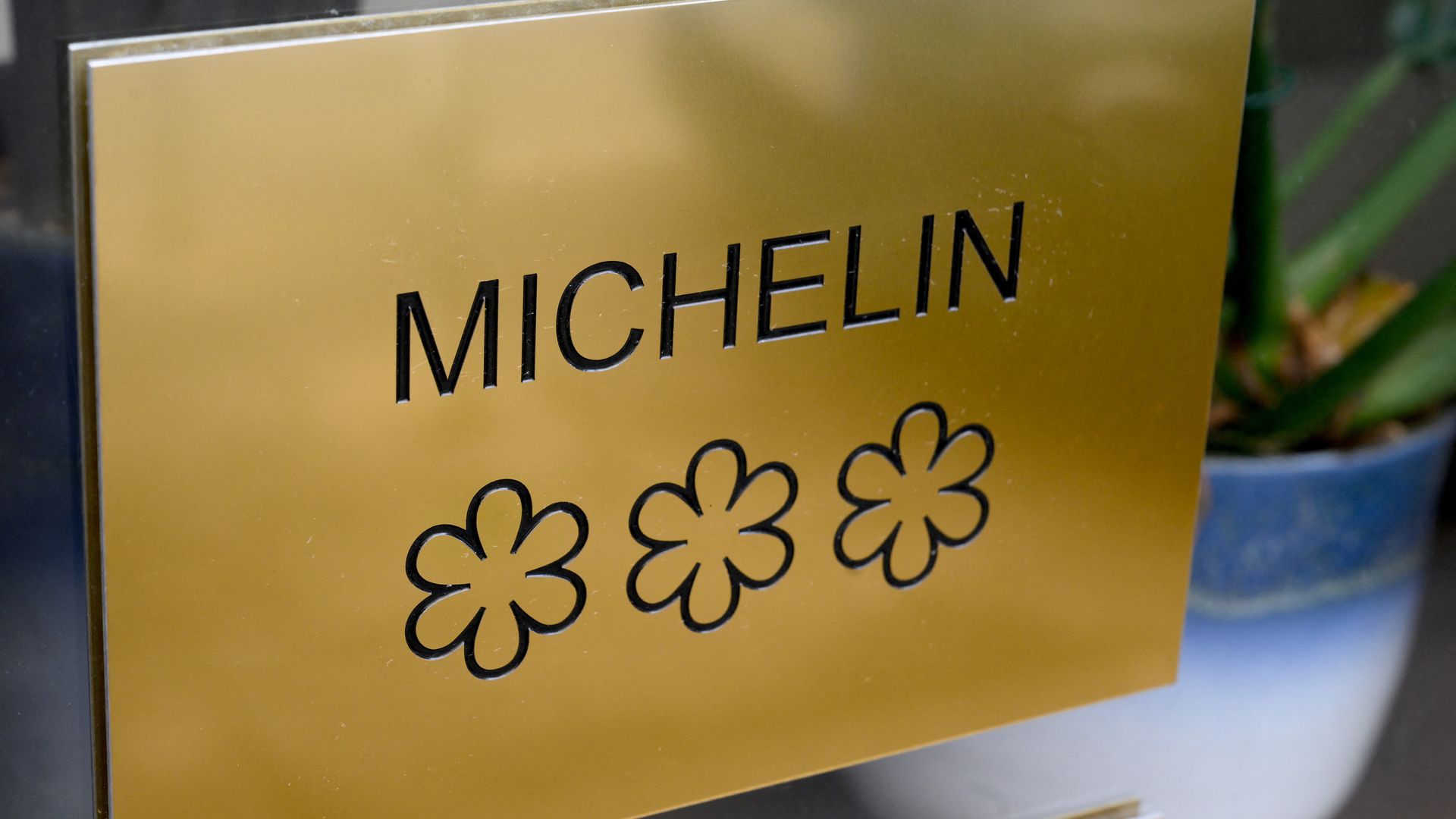 This photograph taken on February 15, 2024 shows a plaque displaying the three stars of the Michelin guide, the highest award of the French gastronomy, on the door of Alexandre Mazzia's AM restaurant. (Photo by Nicolas TUCAT / AFP) (Photo by NICOLAS TUCAT/AFP via Getty Images)