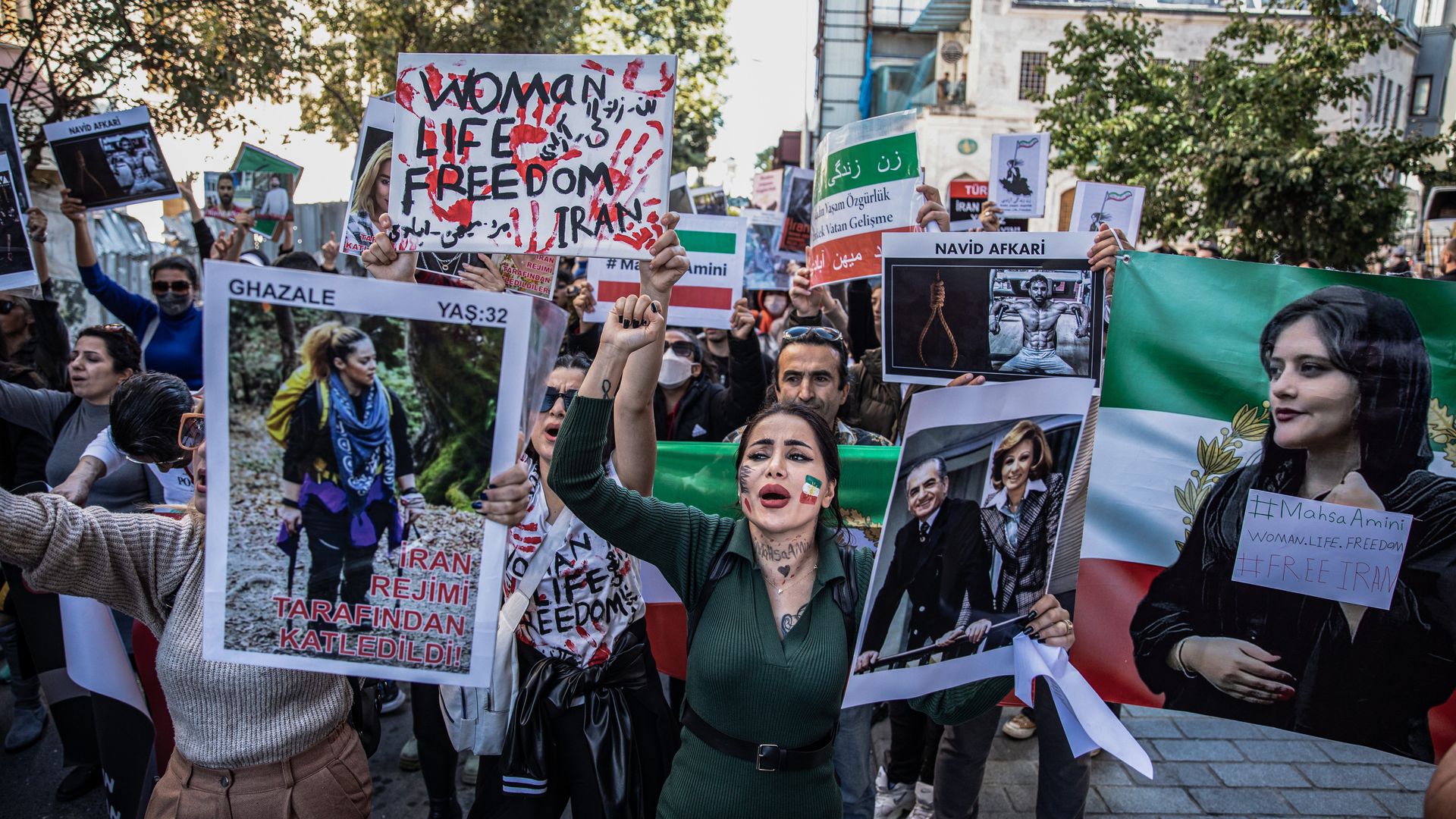Protesters hold placards while chanting