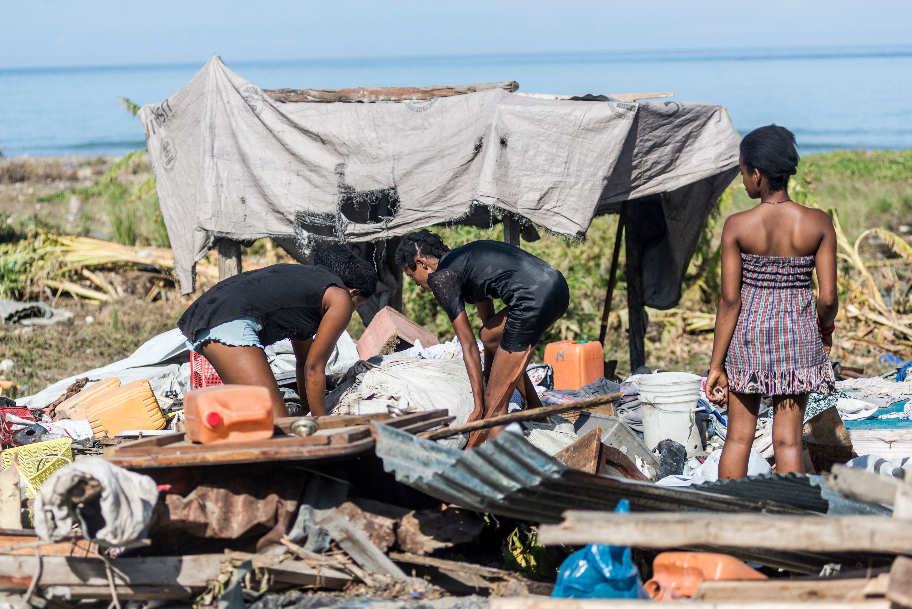 People clean up what remains of their home, as the small houses near the coast were severely damaged after the earthquake in Port-a-Piment, Haiti on Aug. 16.
