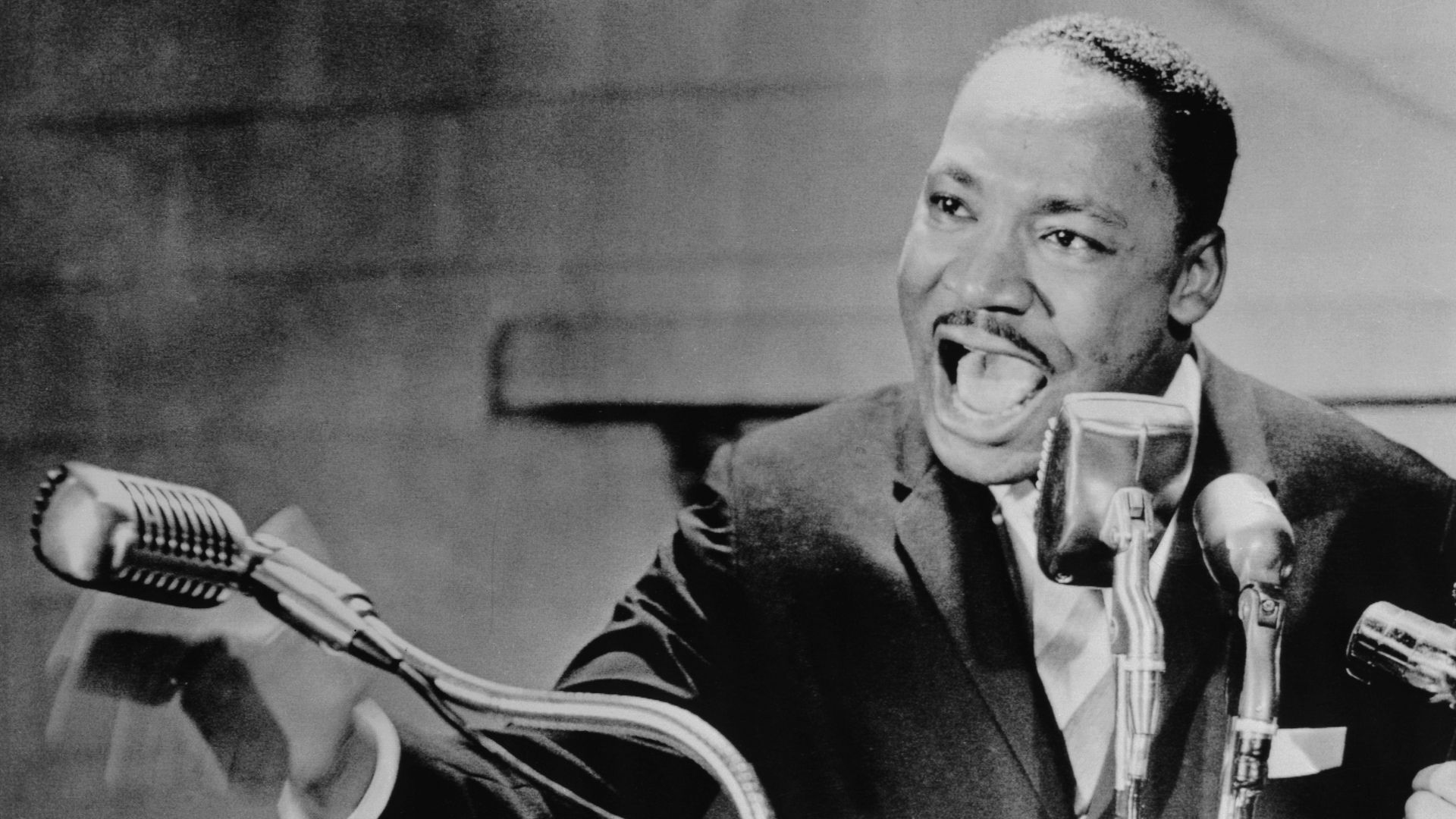 Rev. Martin Luther King Jr. speaks in front of a set of microphones at Fisk University in May 1964.