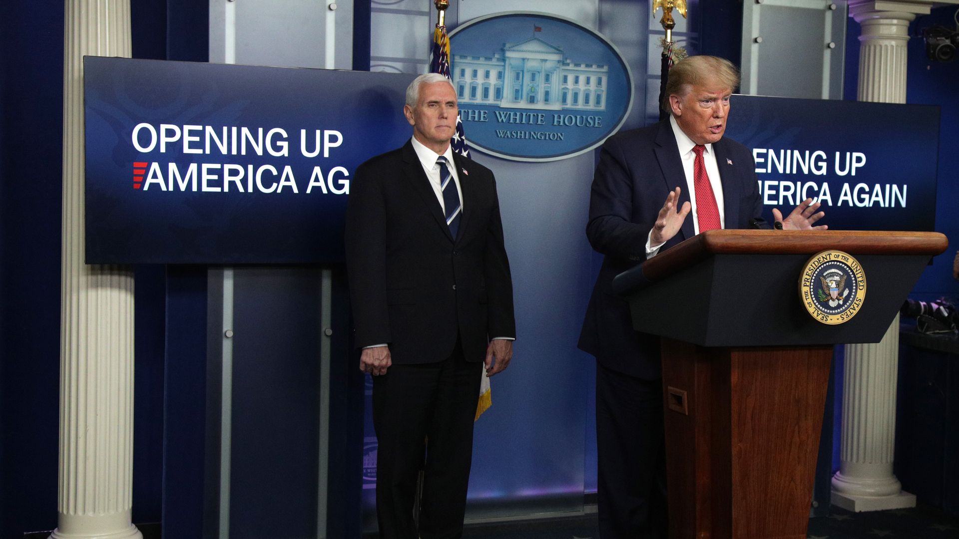 President Donald Trump speaks to press about reopening the economy at the White House while Vice President Mike Pence looks on.