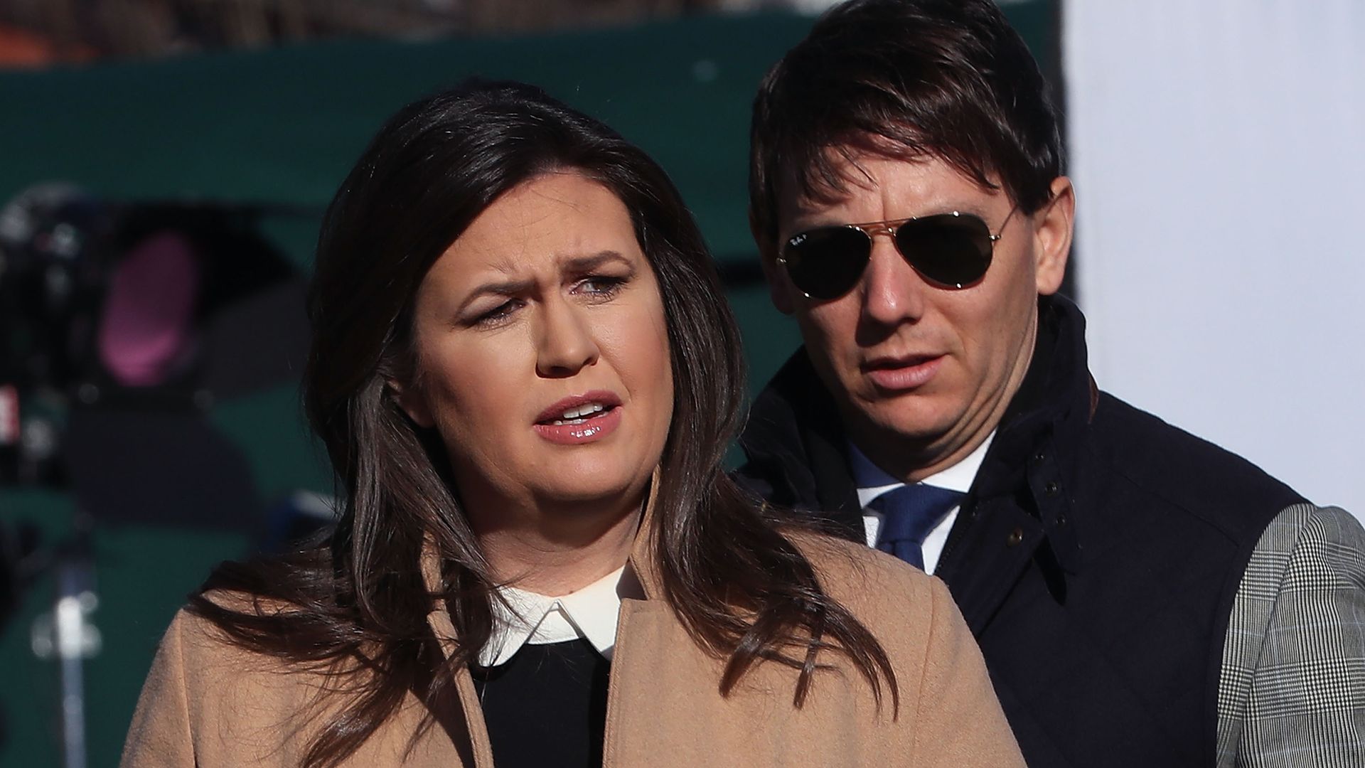Sarah Sanders wears a quote while being interview outside the White House 