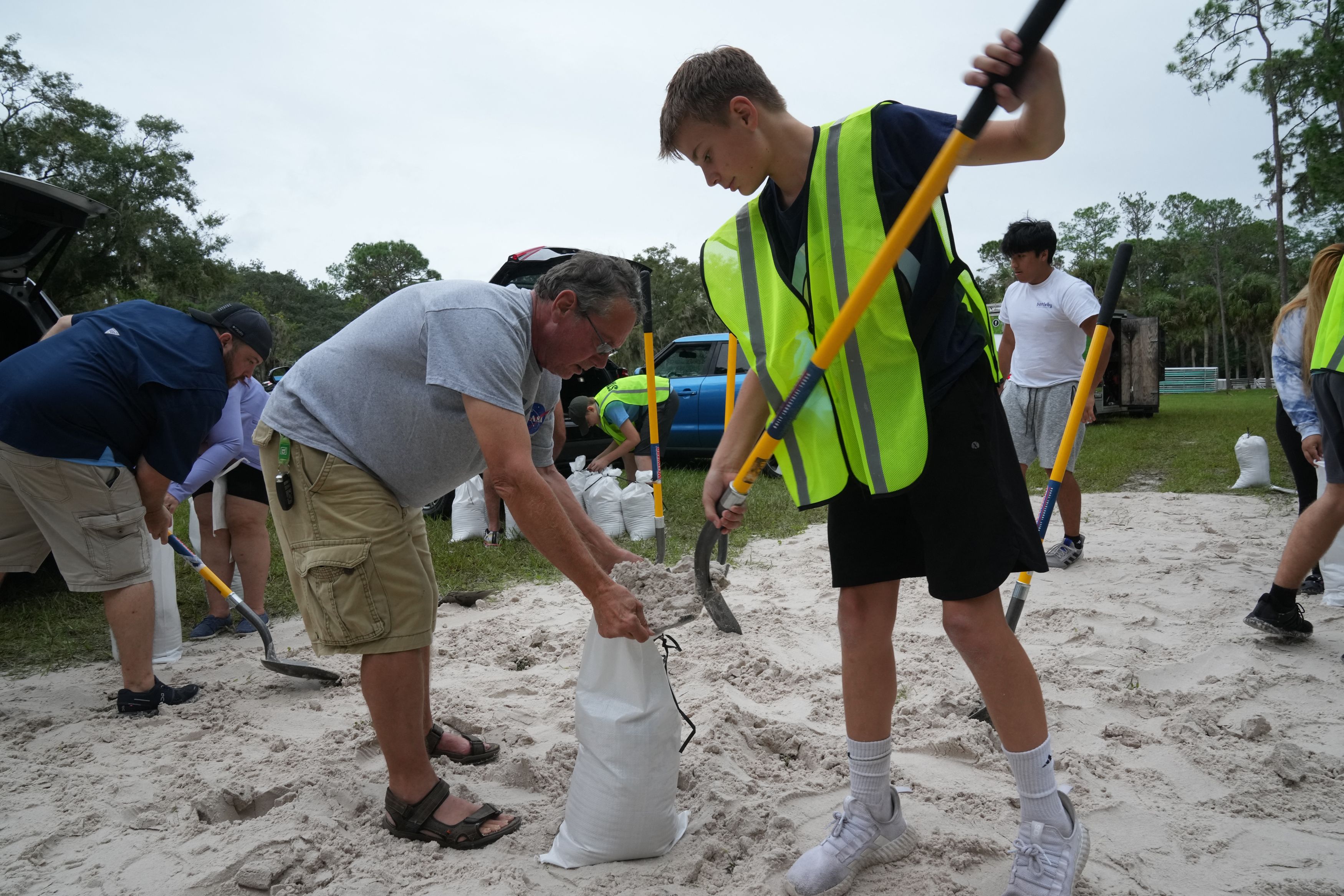 A Park Ranger directs traffic as Pinellas County residents arrive to fill sandbags at John Chestnut Park in Palm Harbor, Florida on October 6, 2024. Florida's governor has declared a state of emergency on Saturday as forecasters warned that Hurricane Milton is expected to make landfall later this we
