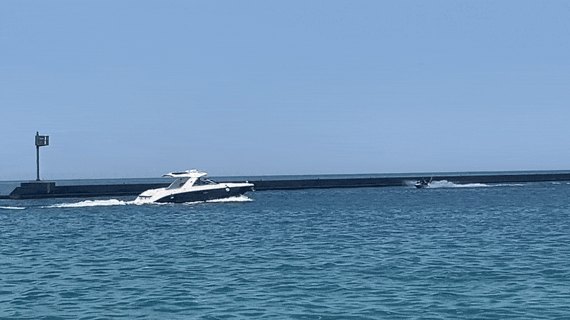 Gif of a boat and jet ski crossing on Lake Michigan