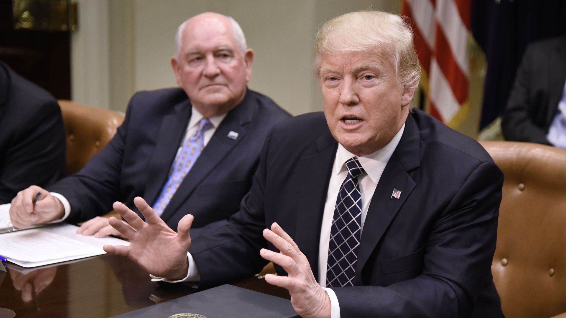 US President Donald speaks as Agriculture Secretary Sonny Perdue looks on during a roundtable.