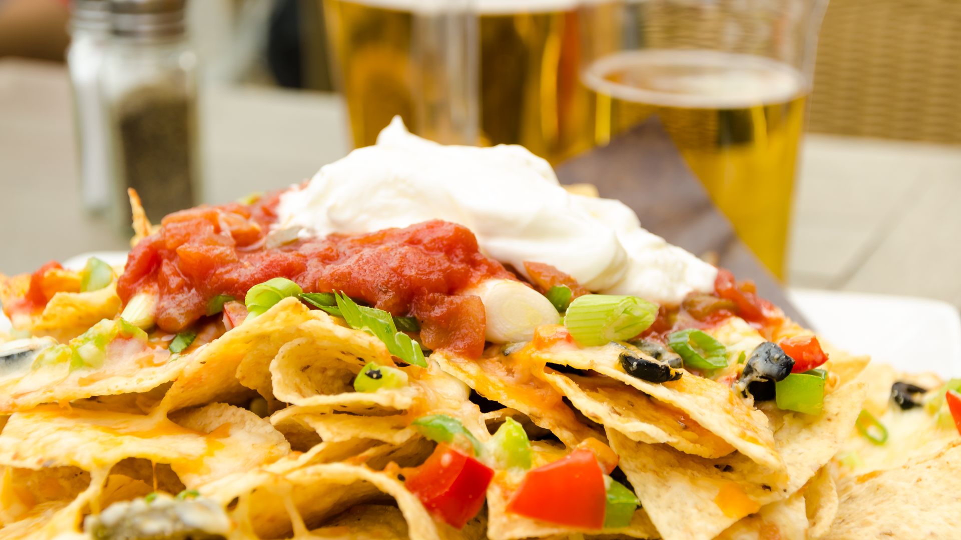 A plate of nachos and beer 