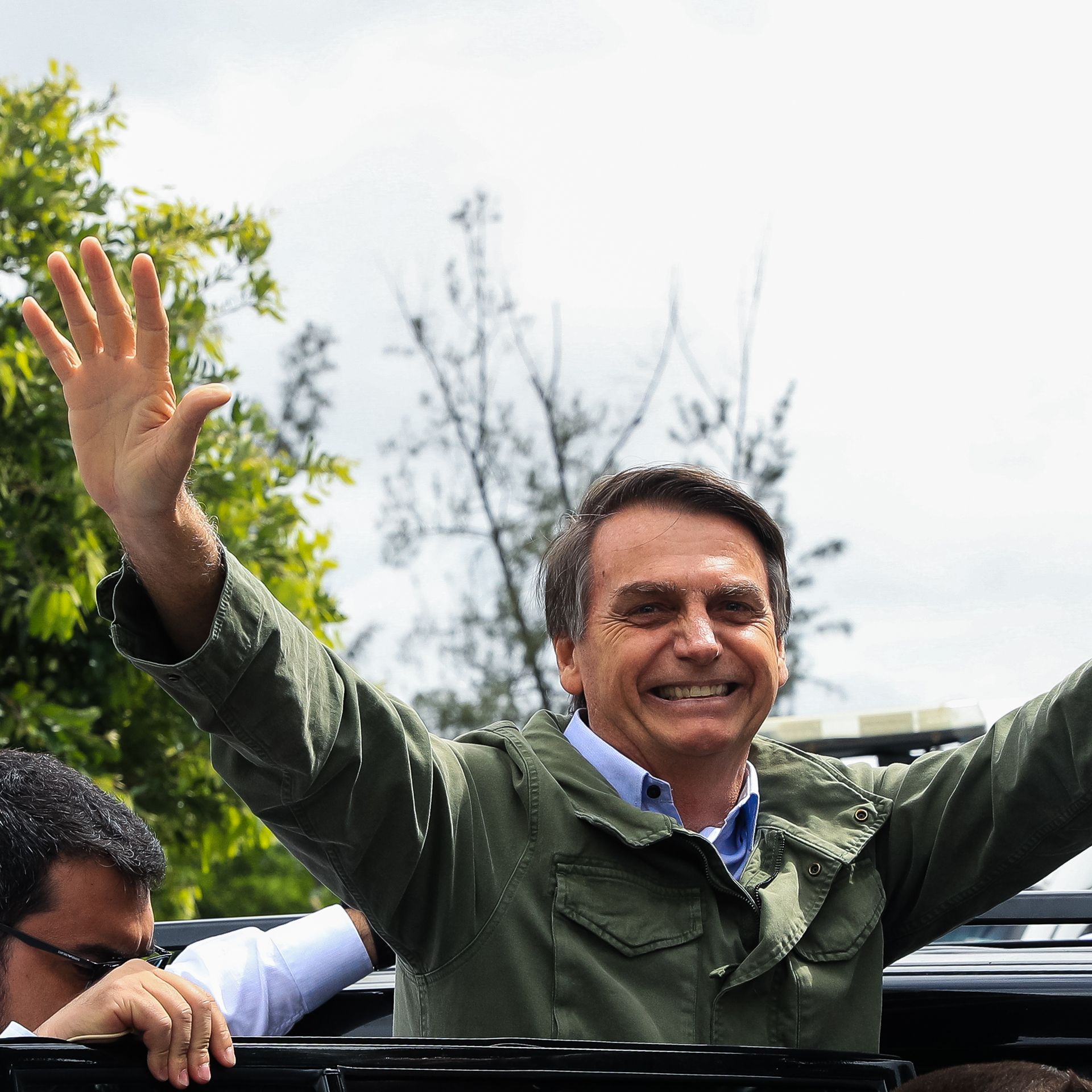 Jair Bolsonaro waves to crowd. 