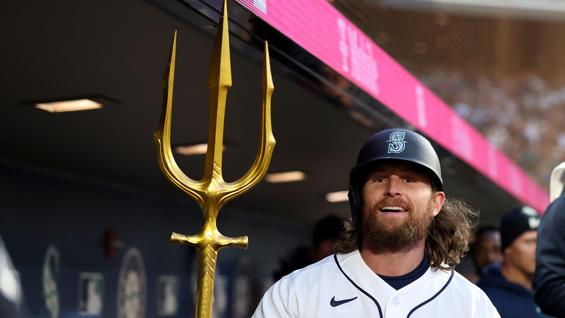 A Seattle Mariner holds the team's trident after a home run. 