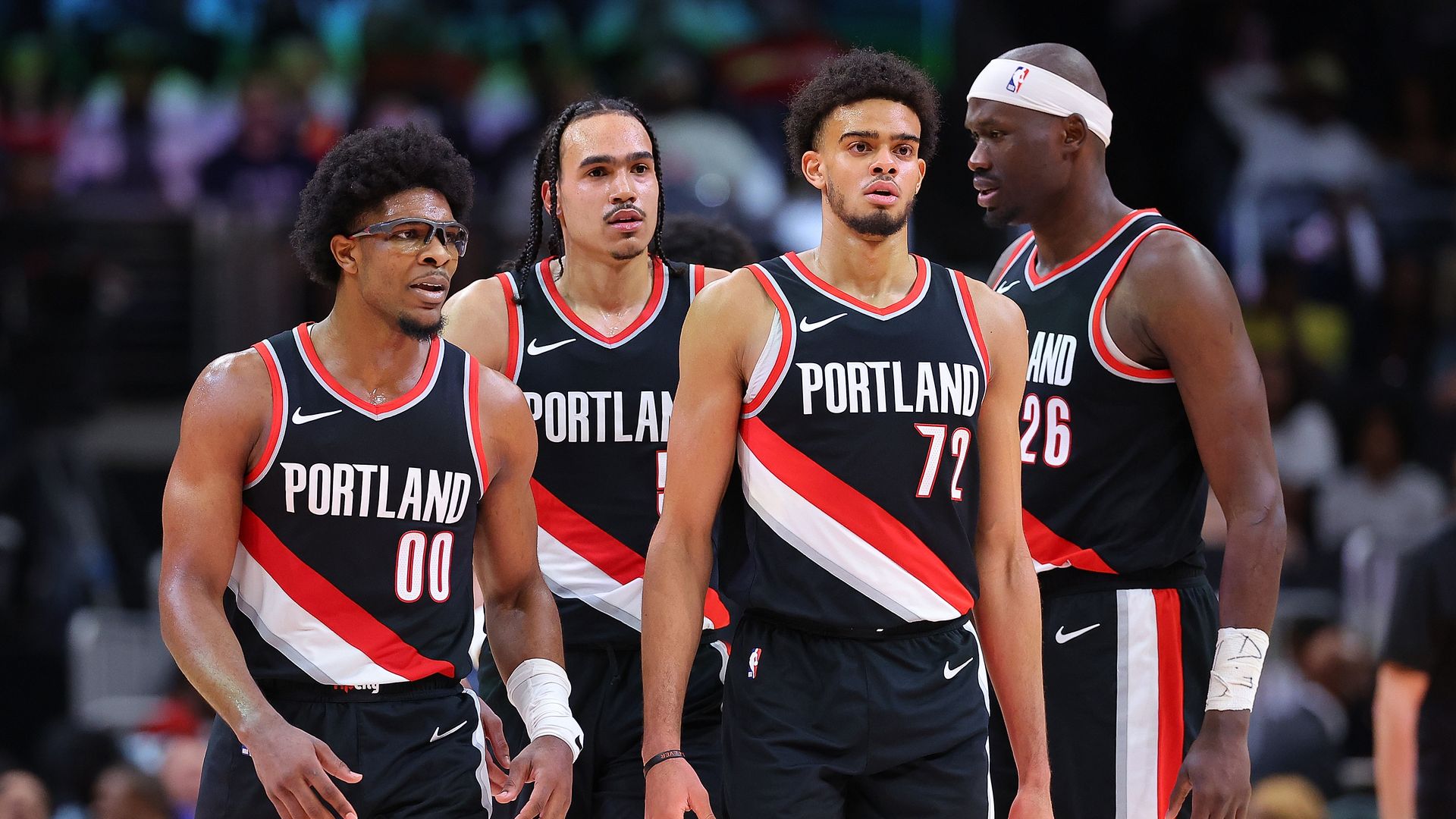 Scoot Henderson #00, Dalano Banton #5, Rayan Rupert #72, and Duop Reath #26 of the Portland Trail Blazers walk to the bench during a timeout against the Atlanta Hawks in the fourth quarter at State Farm Arena on March 27, 2024