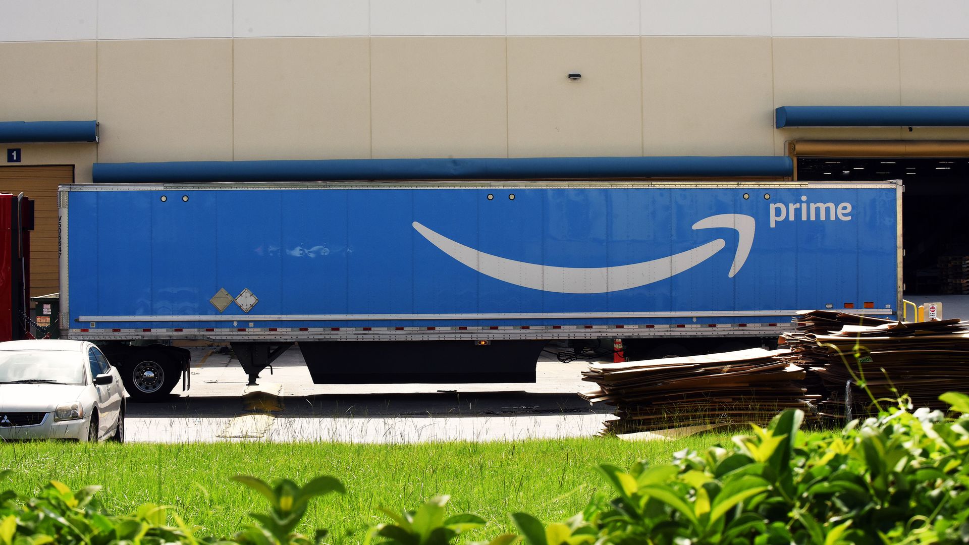 A big blue truck with the Amazon logo on it