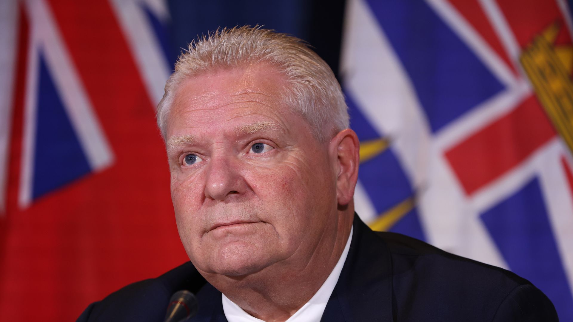 Doug Ford wearing a navy jacket and tie with a white shirt 