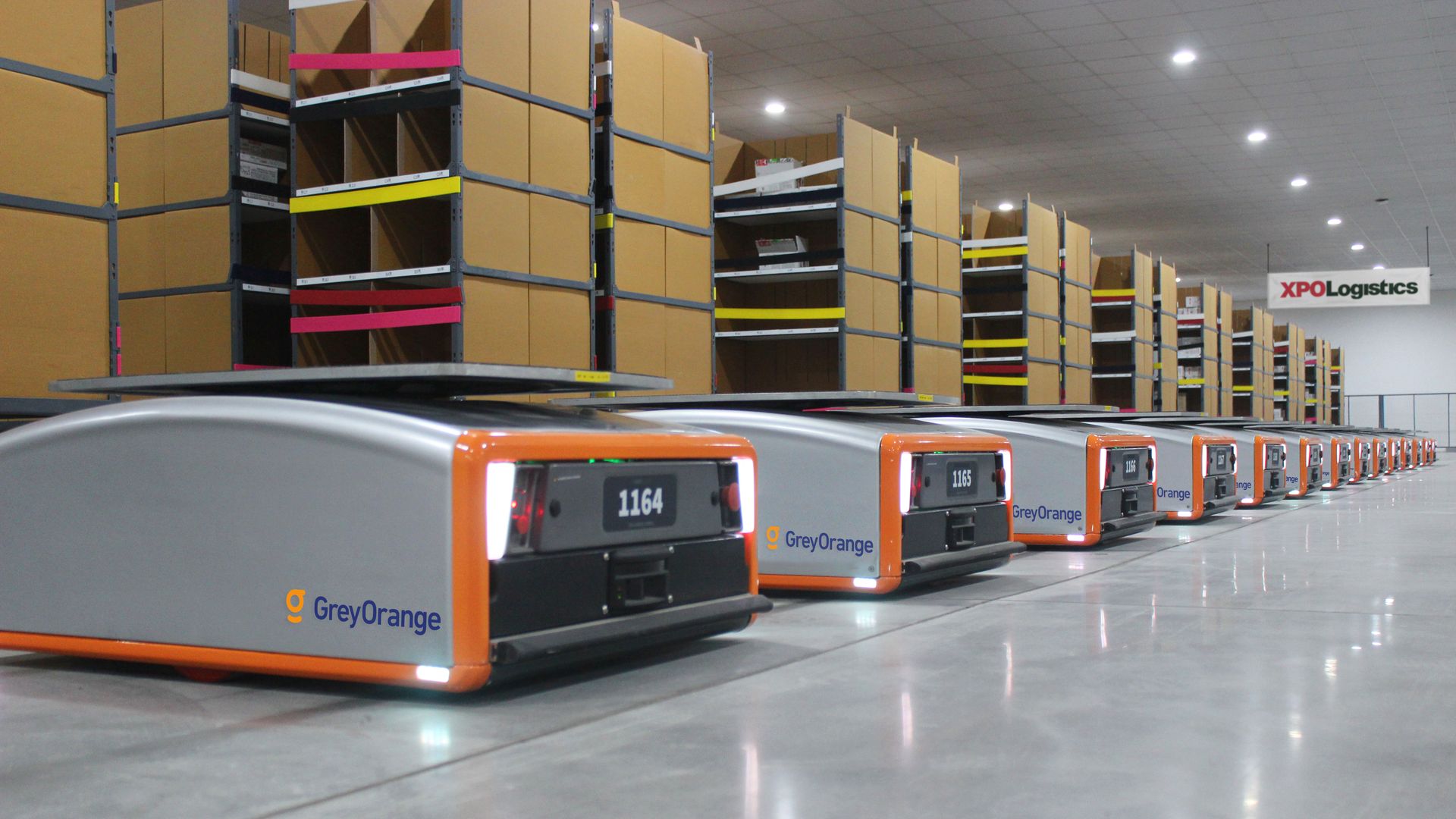 Line of robots in an XPO Logistics warehouse.