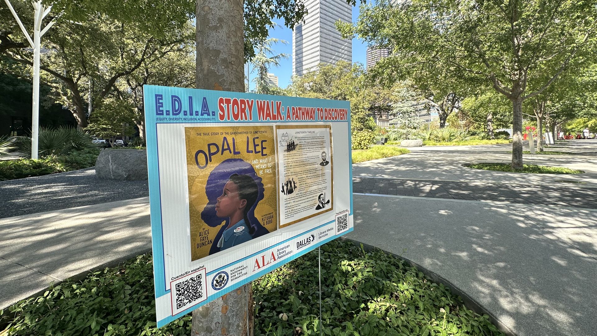 A photo of a sign with a book at a Dallas park 