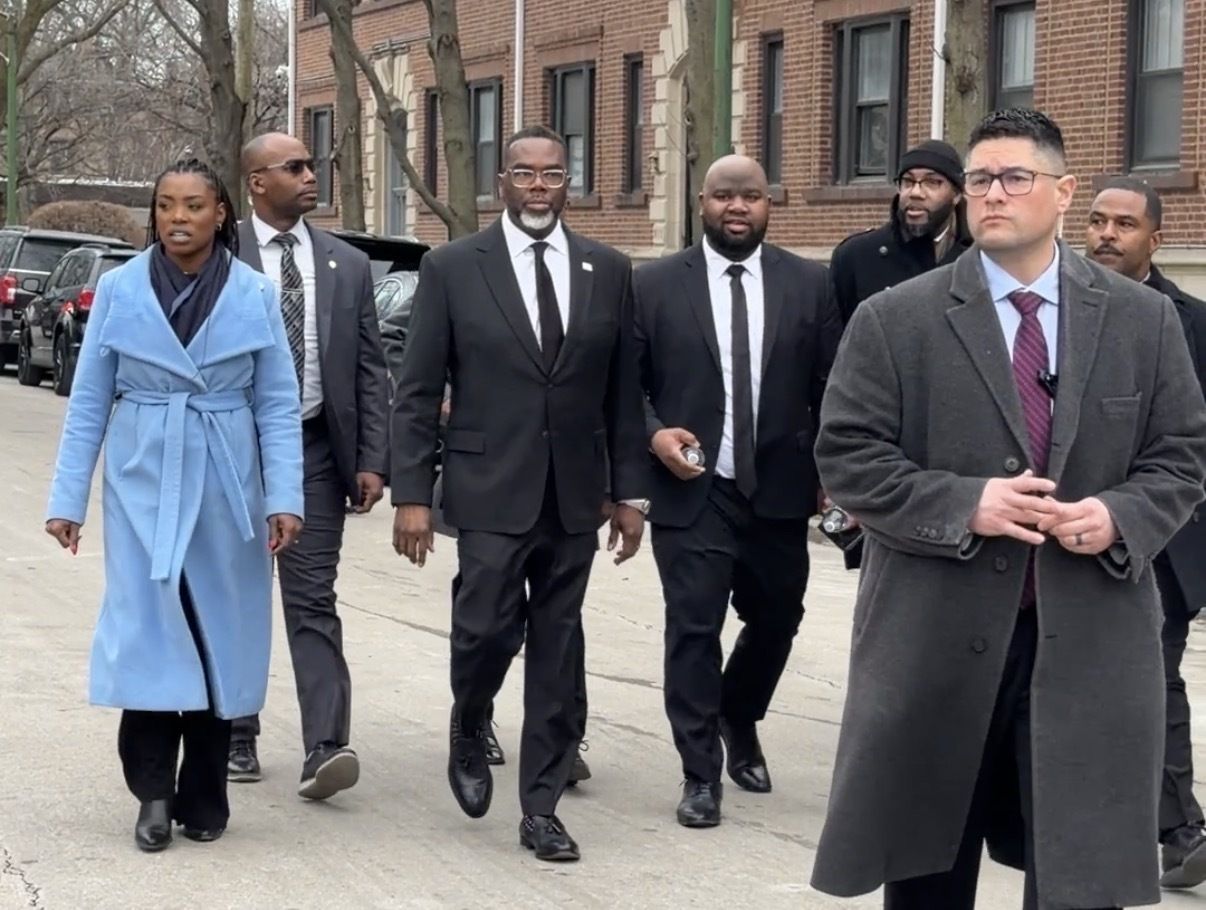 People in suits walking down a street