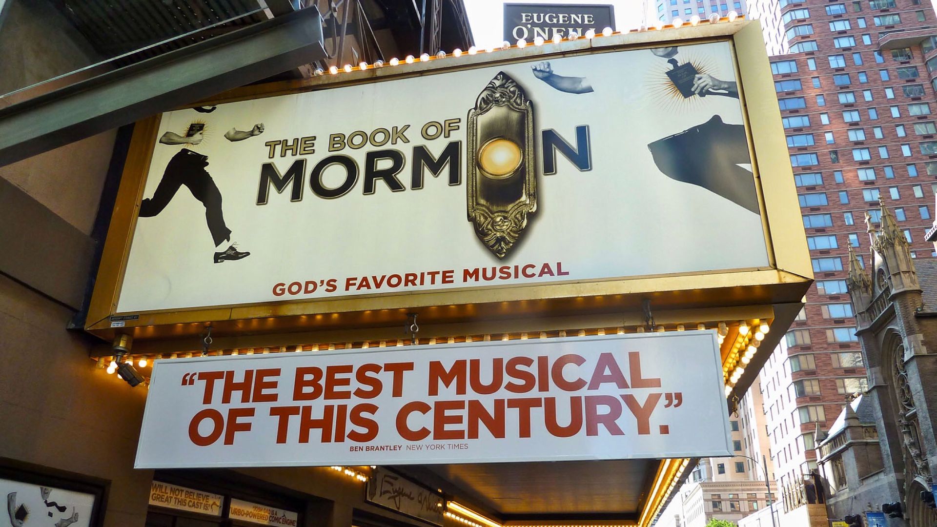 A marquee sign reads "The Book of Mormon" and "The best musical of this century."