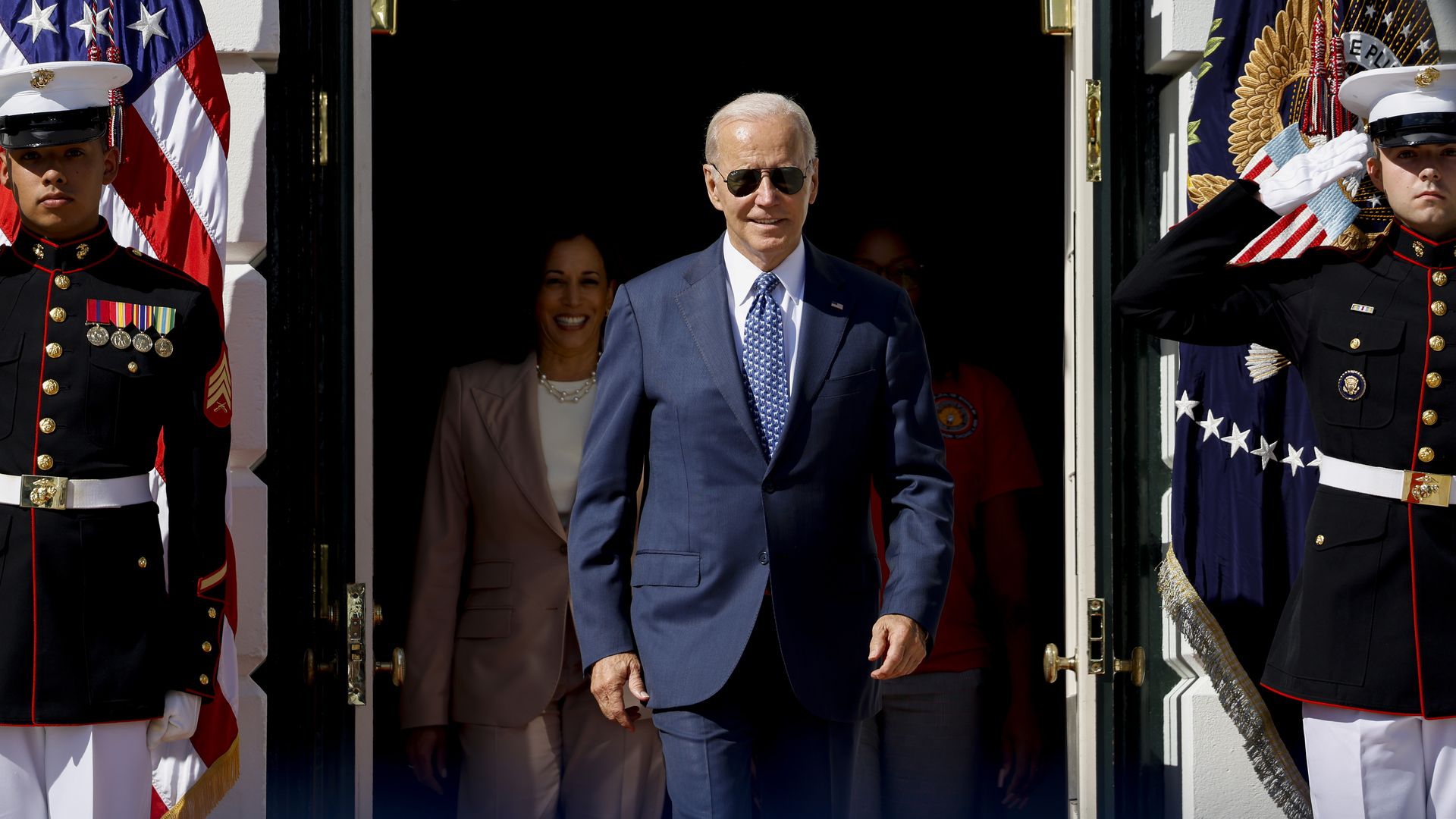 President Joe Biden walking through a door 